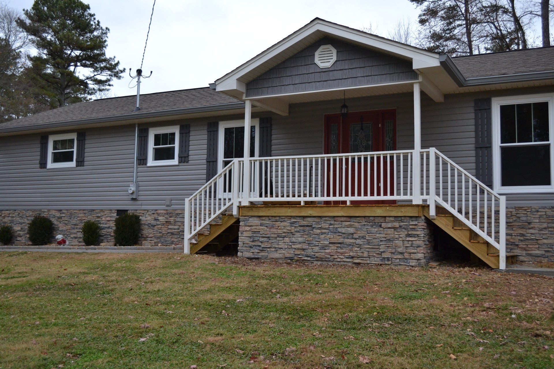 The front of a house with a porch and stairs