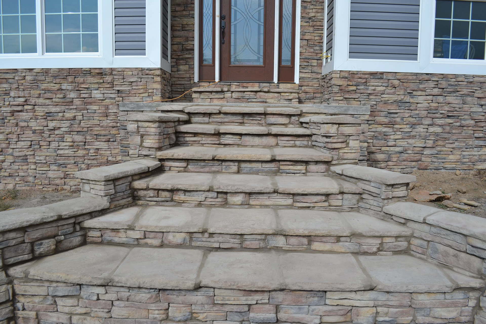 Stone steps leading up to the front door of a house