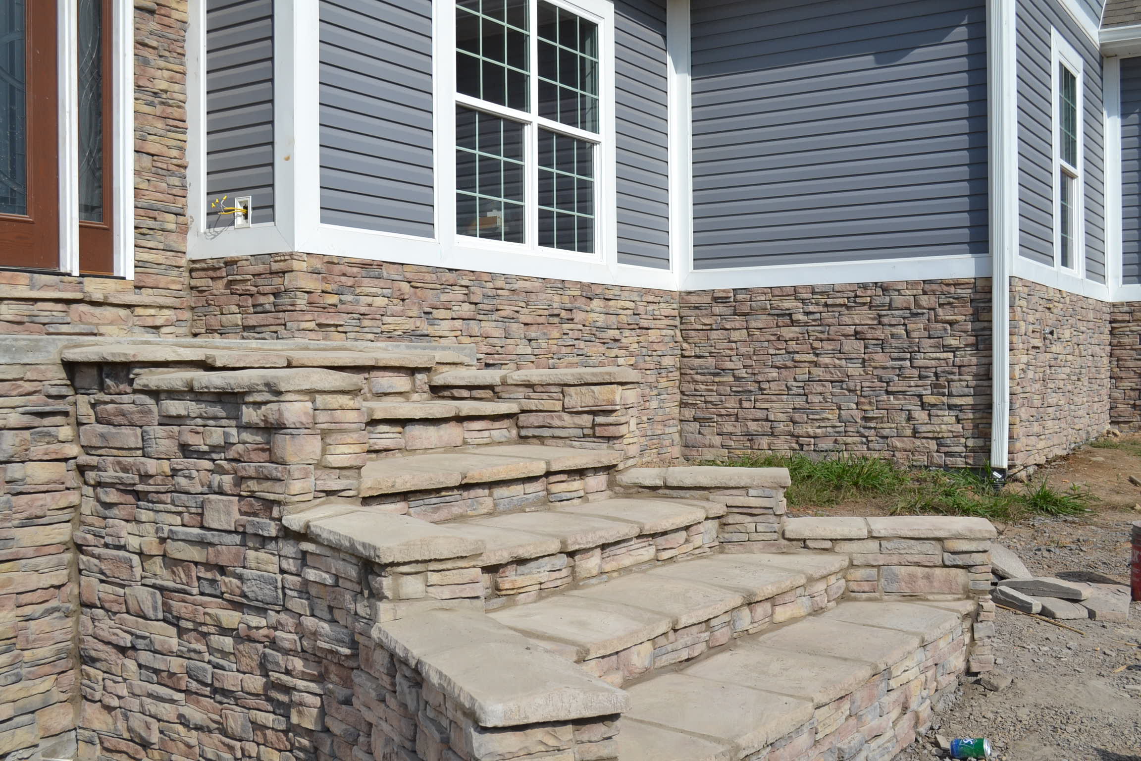 A house with stone steps leading up to the front door.