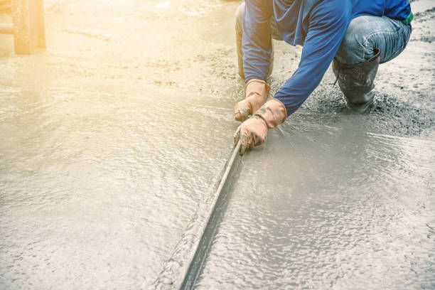 Gator State Paving & Masonry worker troweling wet concrete in Brooksville, FL