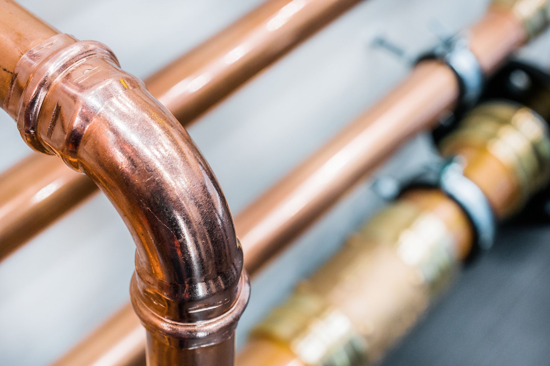 Close-up of shiny new copper pipes, showcasing gas fitters installing premium plumbing systems.