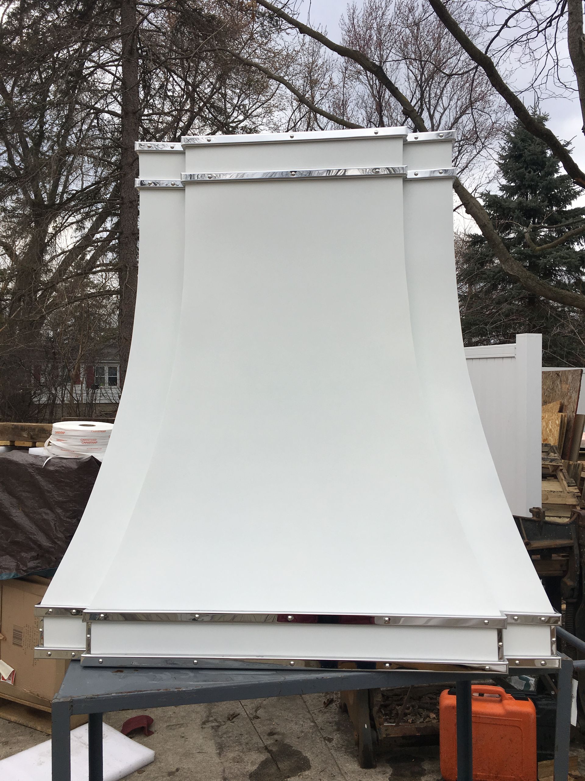 A white hood is sitting on top of a table.