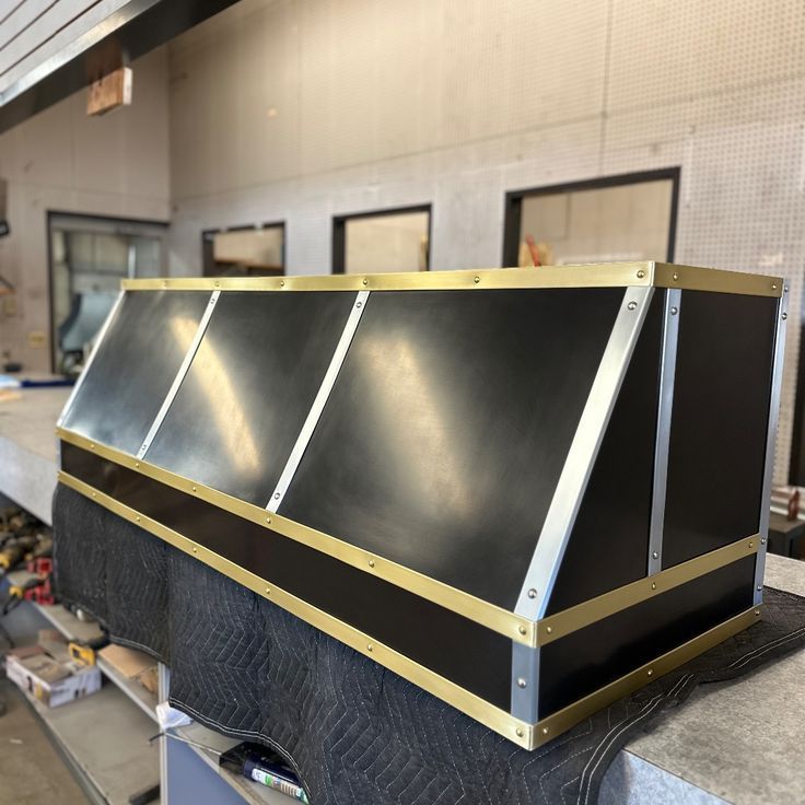 A black box with gold trim sits on a table