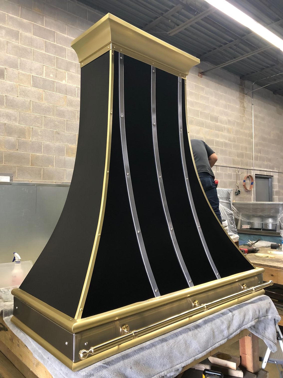 A black and gold hood is sitting on top of a table.