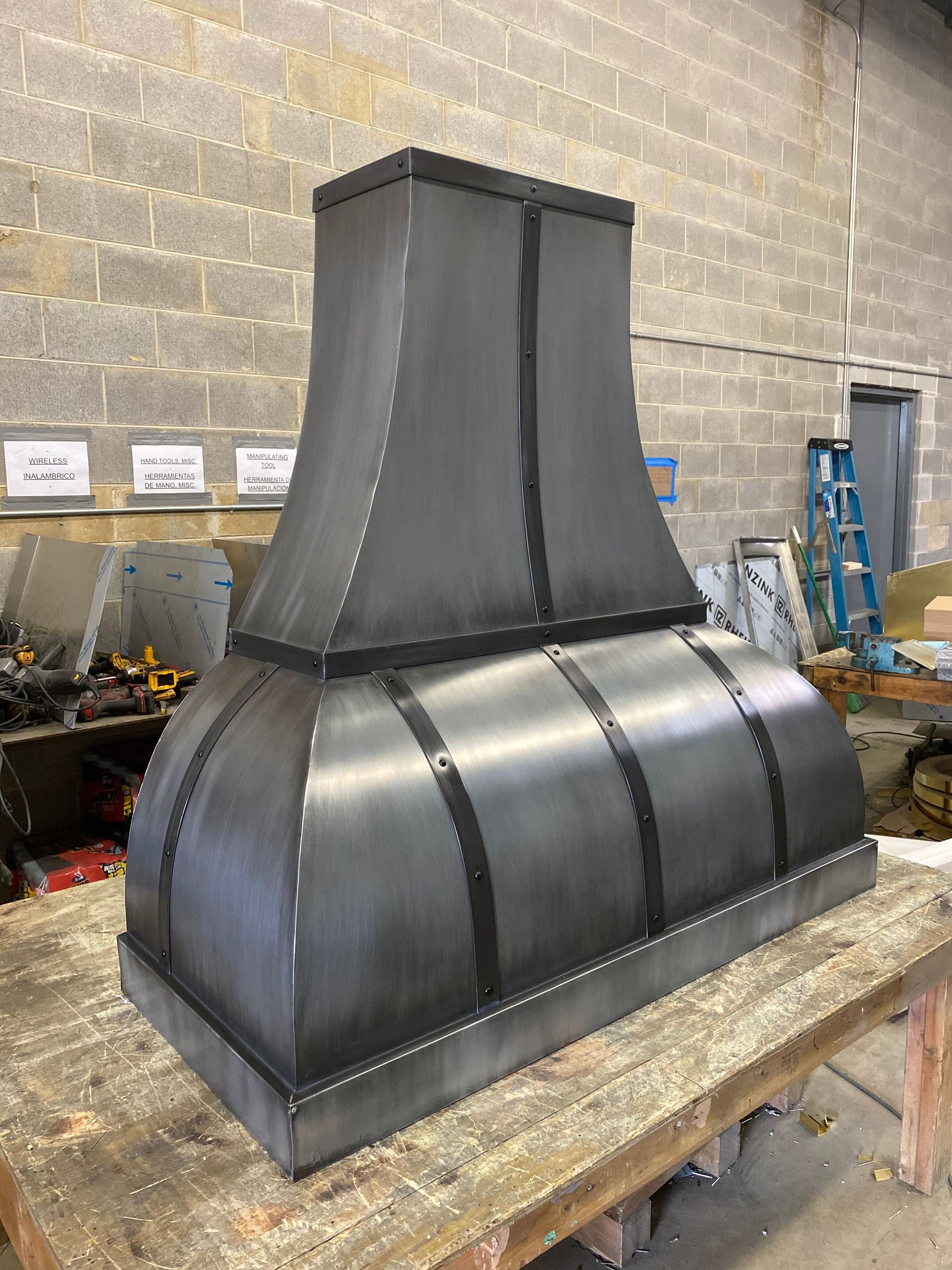 A large metal object is sitting on top of a wooden table.