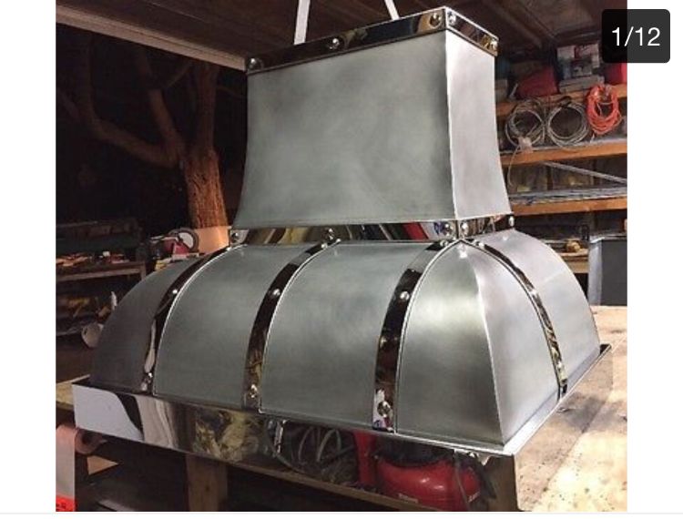 A picture of a stainless steel hood with the number 1/12 at the bottom