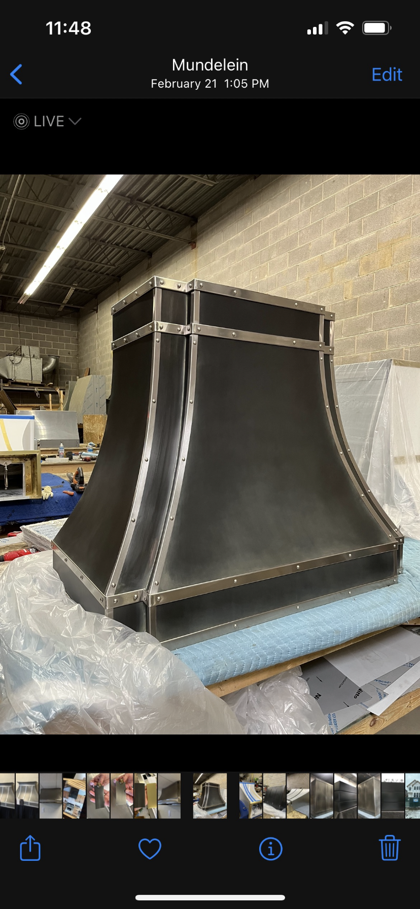 A black hood is sitting on top of a table in a room.