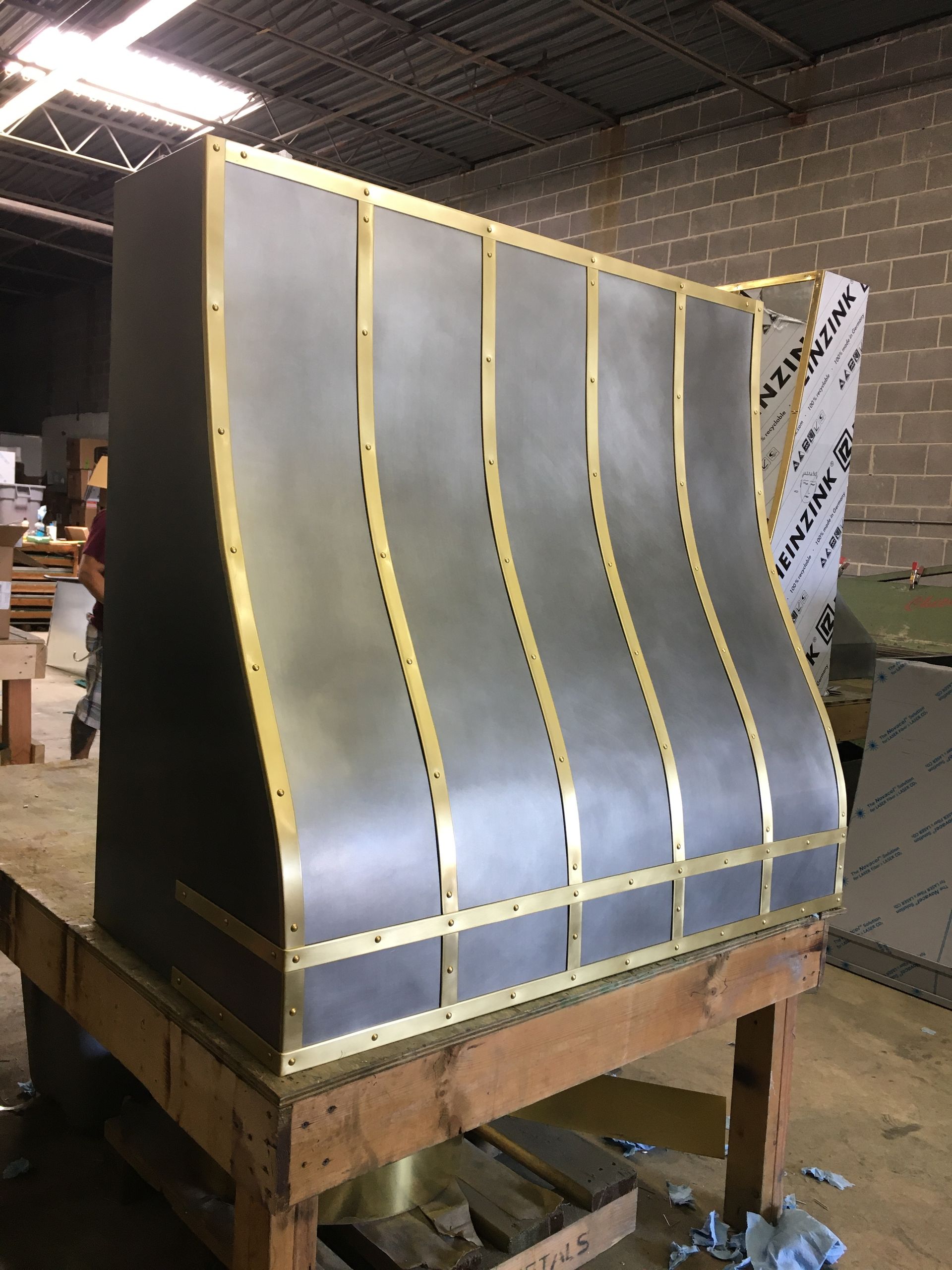 A large metal object is sitting on top of a wooden table.