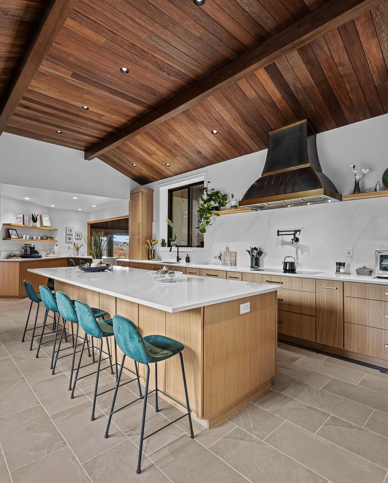 A kitchen with a wooden ceiling and a large island