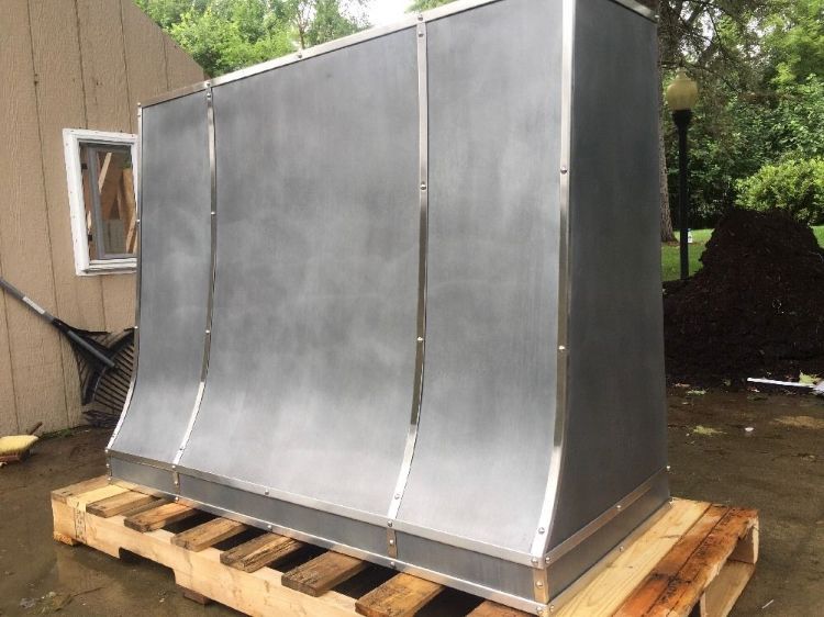 A large metal object is sitting on top of a wooden pallet.