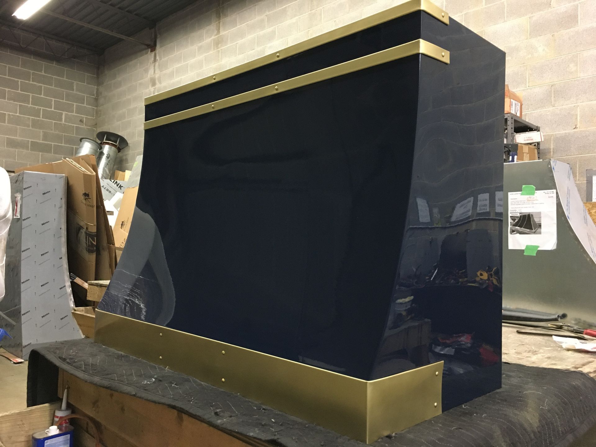 A blue and gold cabinet is sitting on top of a wooden table.