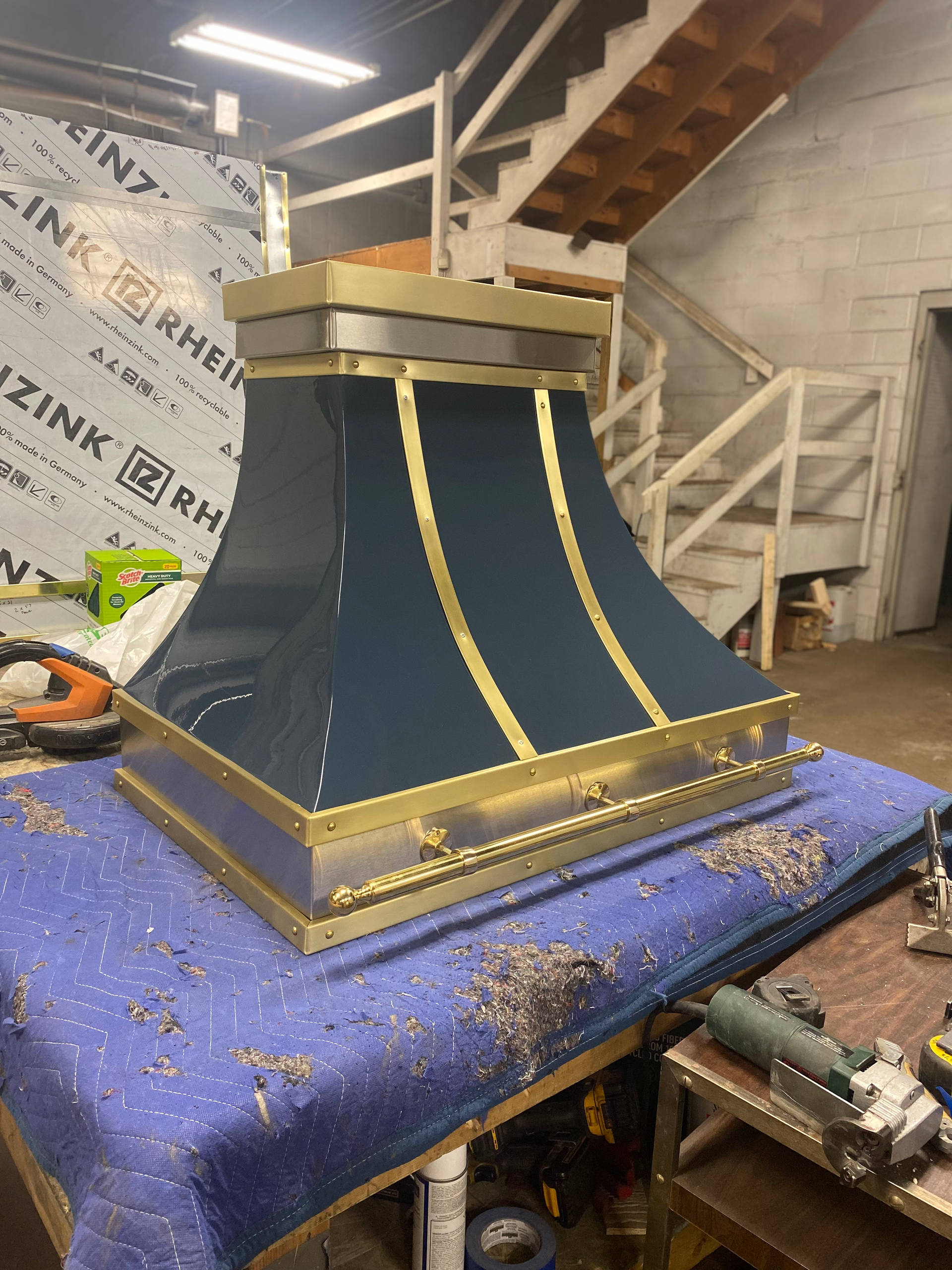 A black and gold hood is sitting on top of a table.