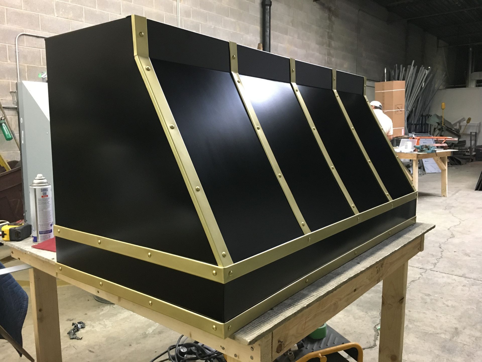 A black box is sitting on top of a wooden table.