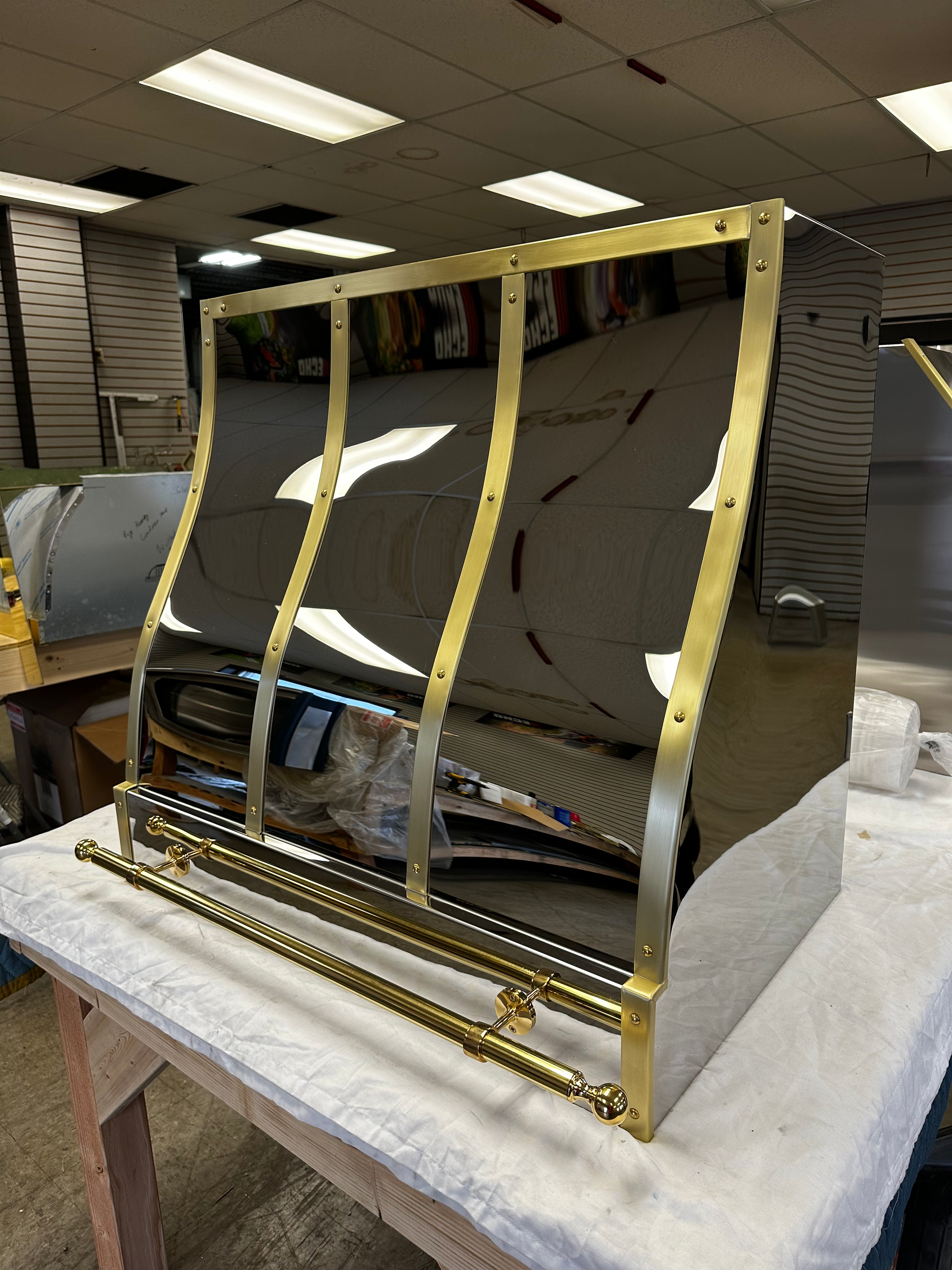 A stainless steel and brass item is sitting on a table