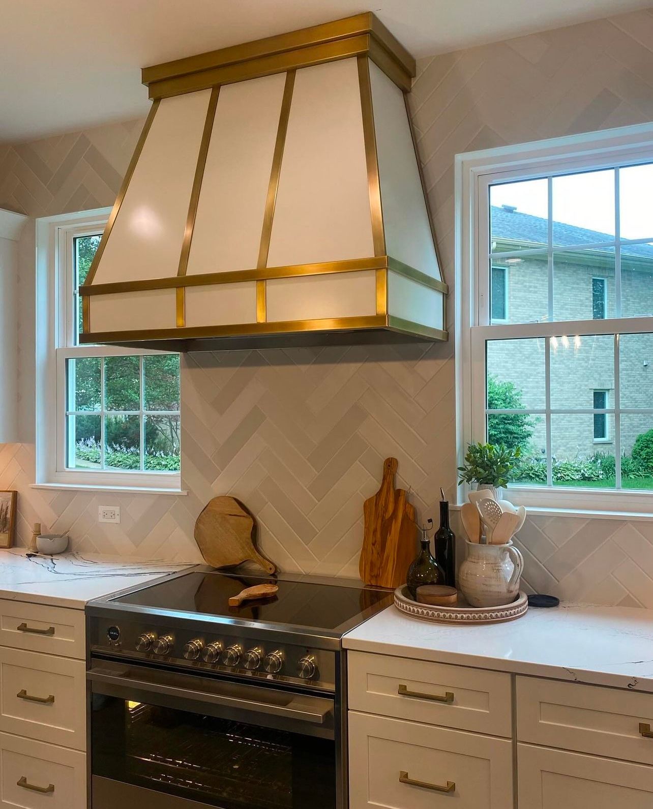 A kitchen with a stove and a hood above it