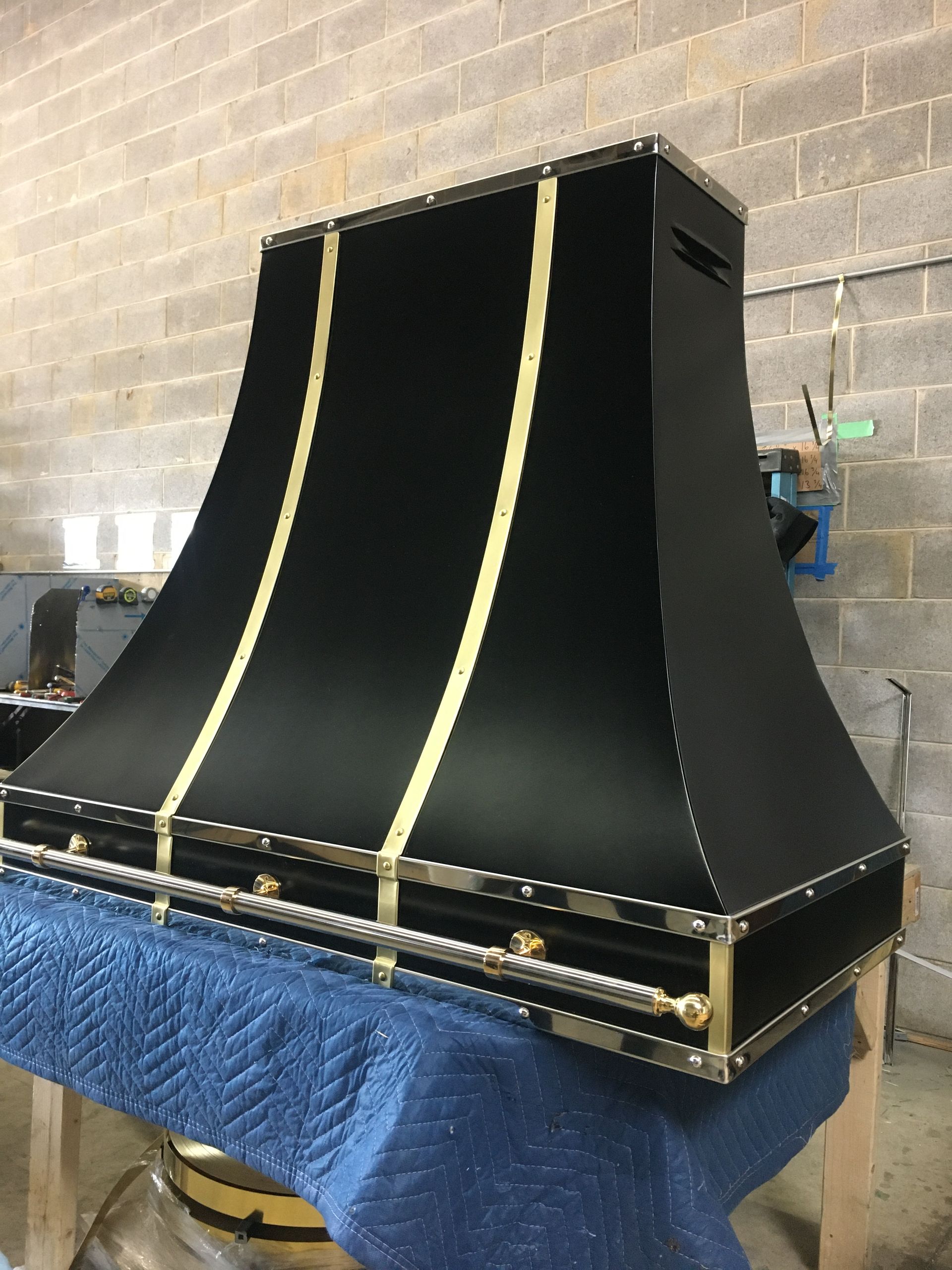 A black and gold hood is sitting on a table