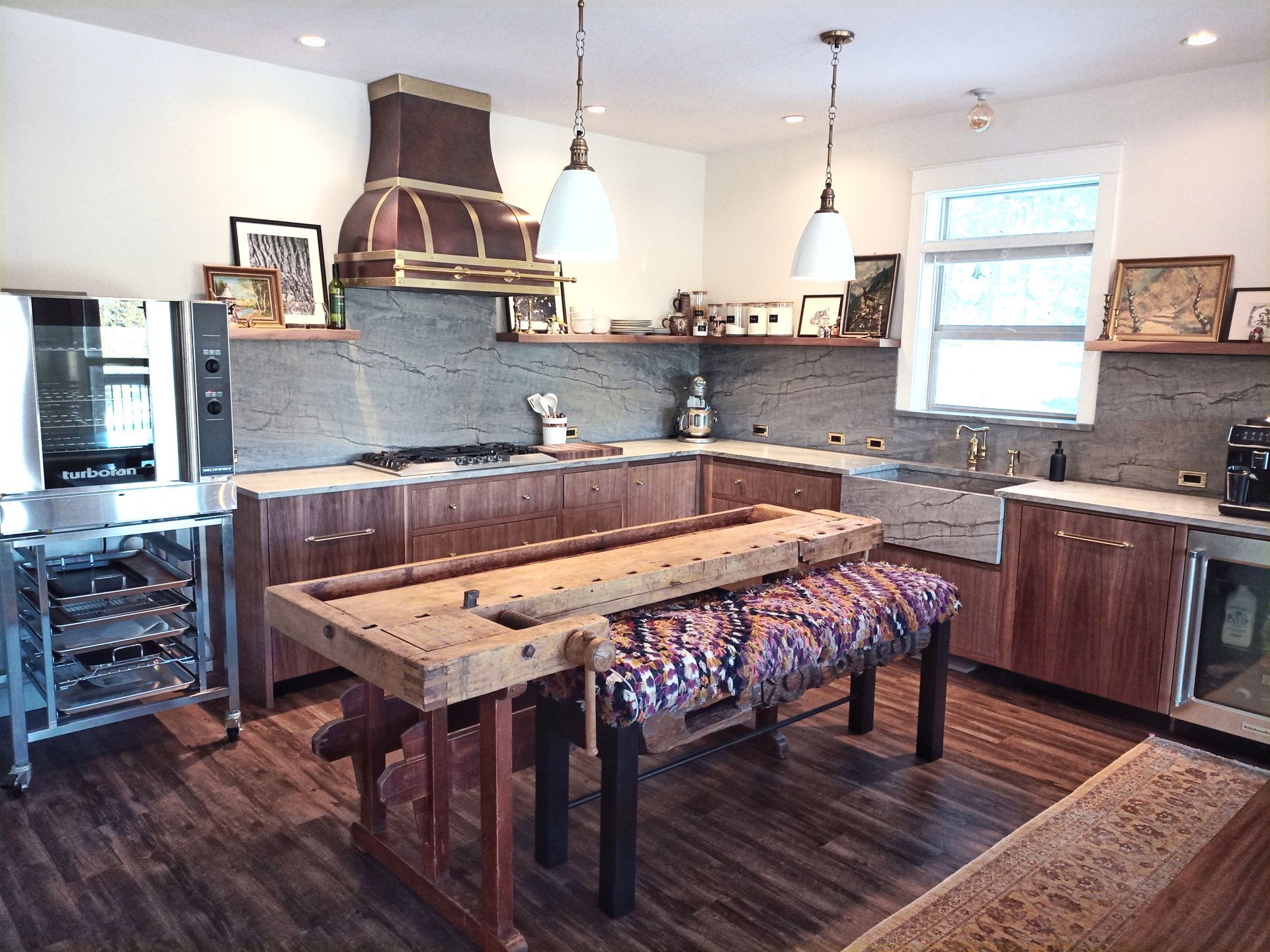 A kitchen with wooden cabinets and a wooden workbench