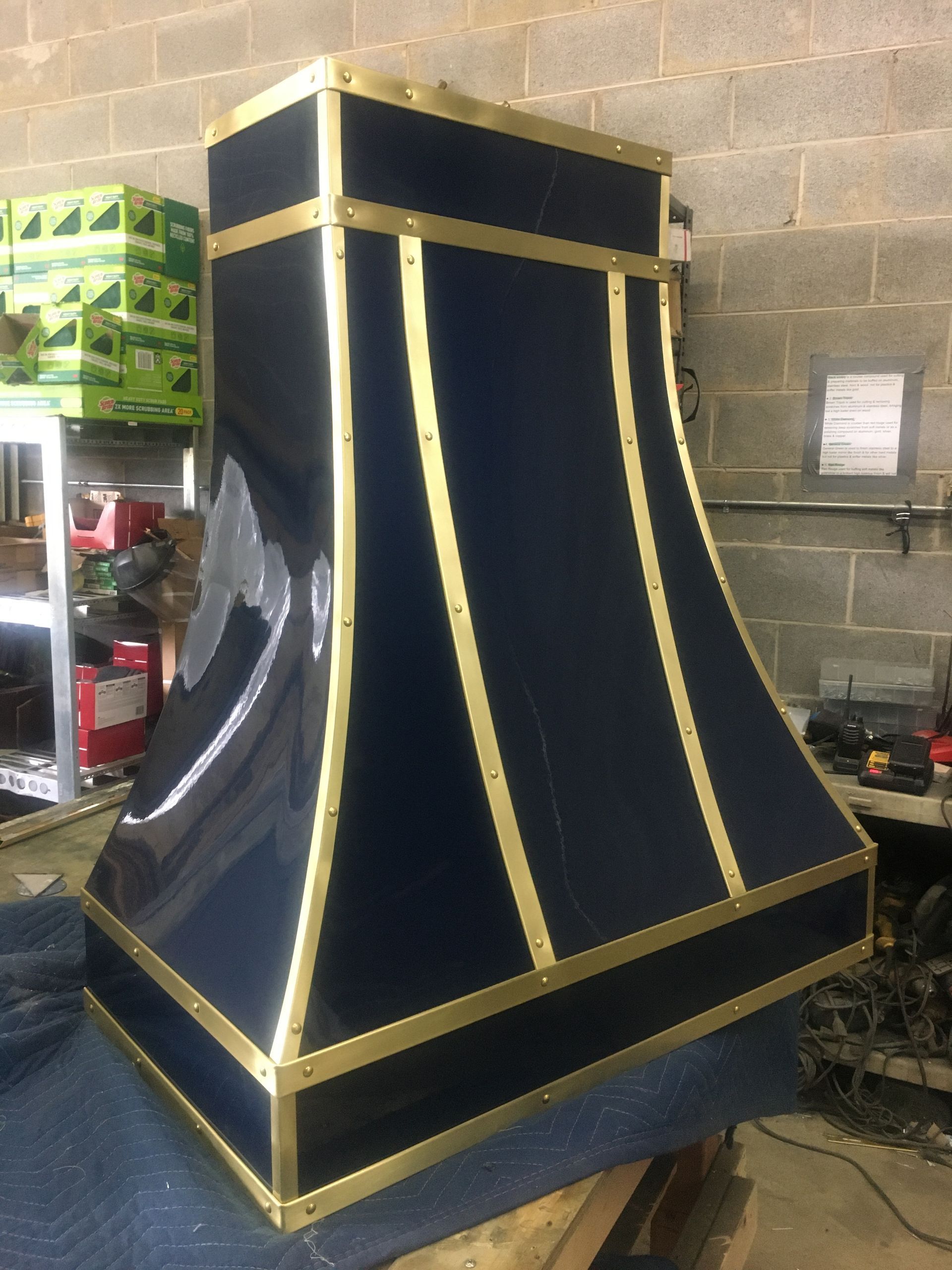 A black and gold hood is sitting on a table