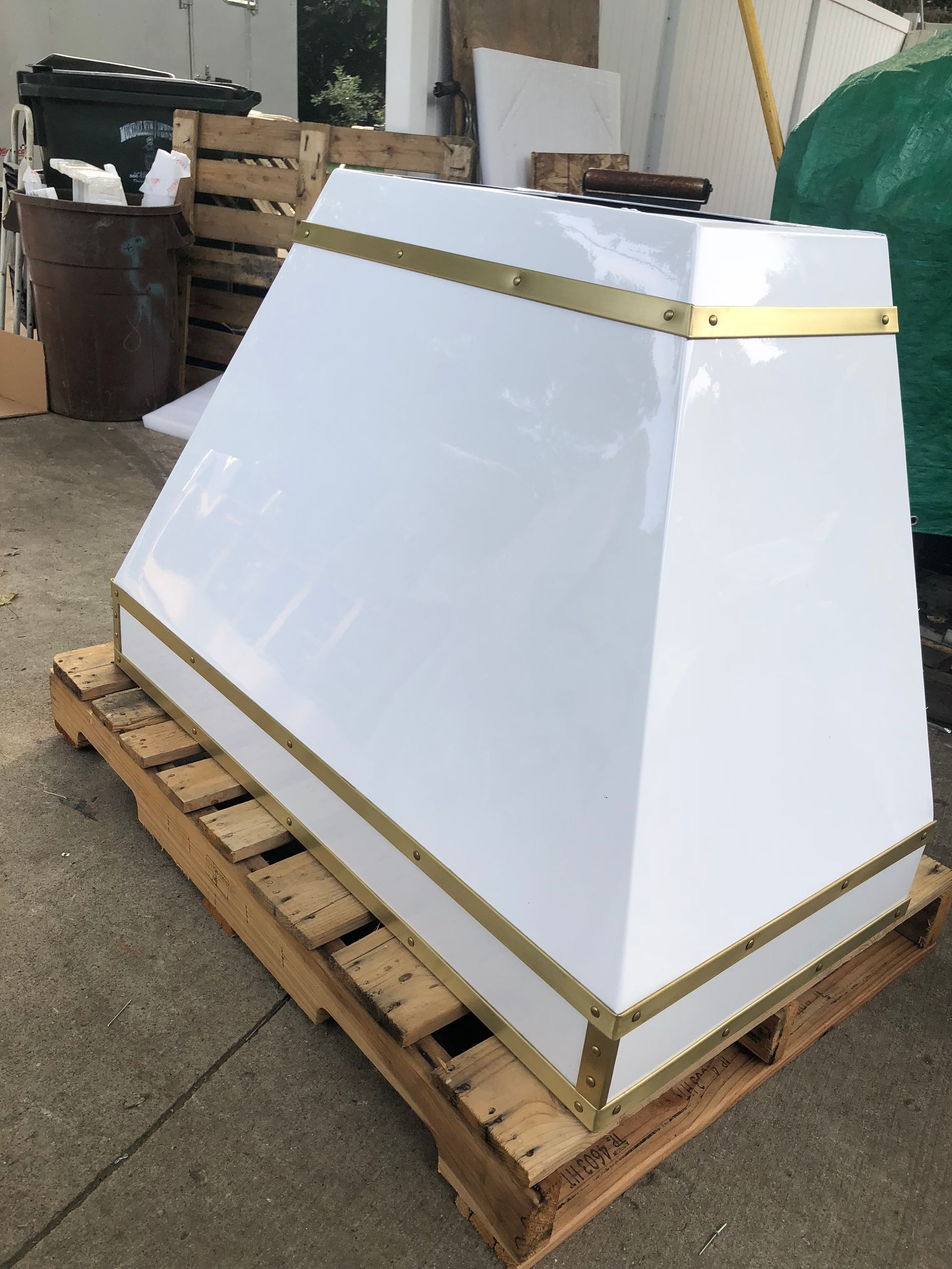 A white item is sitting on a wooden pallet