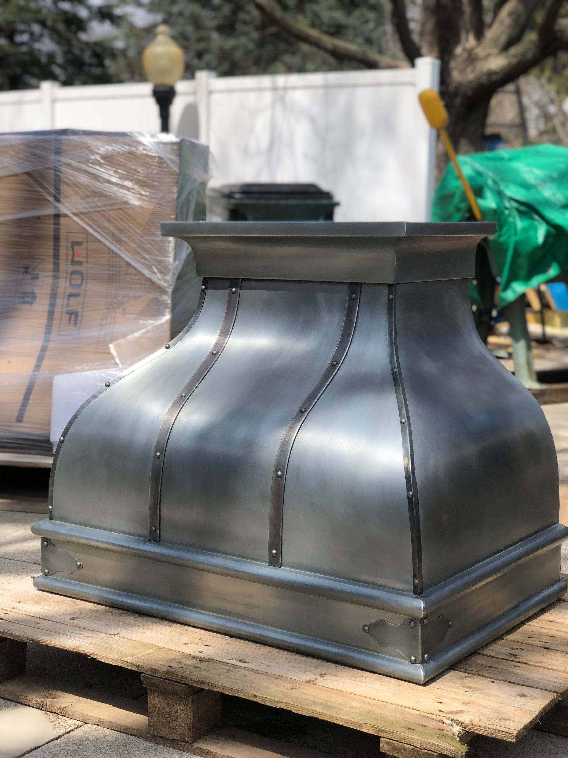 A large metal object is sitting on top of a wooden pallet.