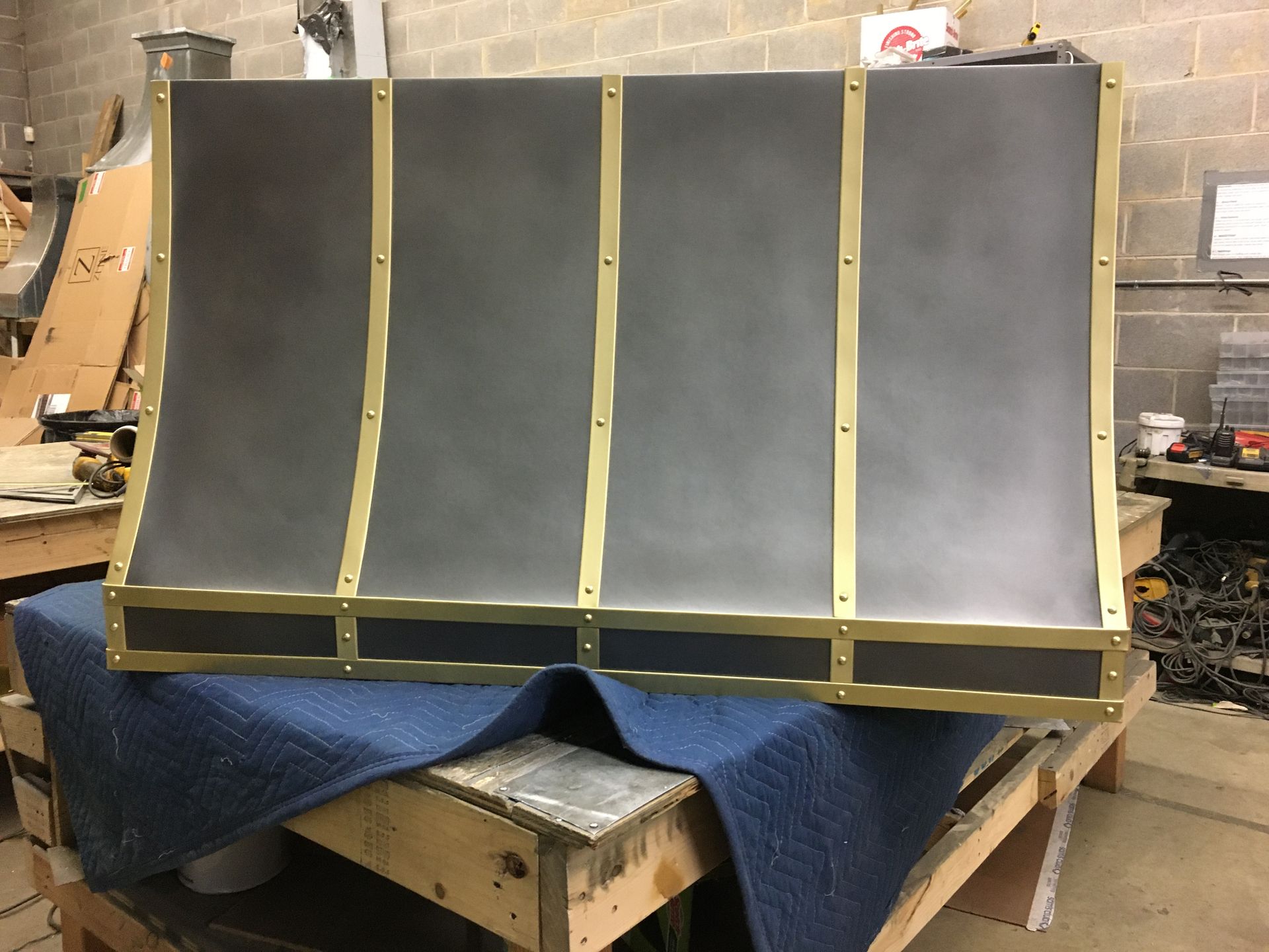 A large piece of metal is sitting on top of a wooden table.