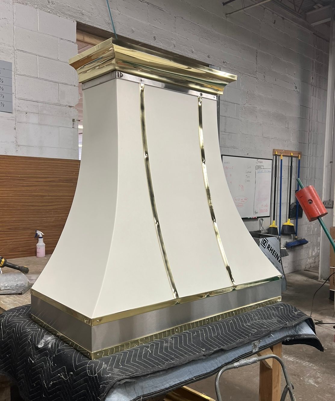 A white and gold hood is sitting on top of a table.
