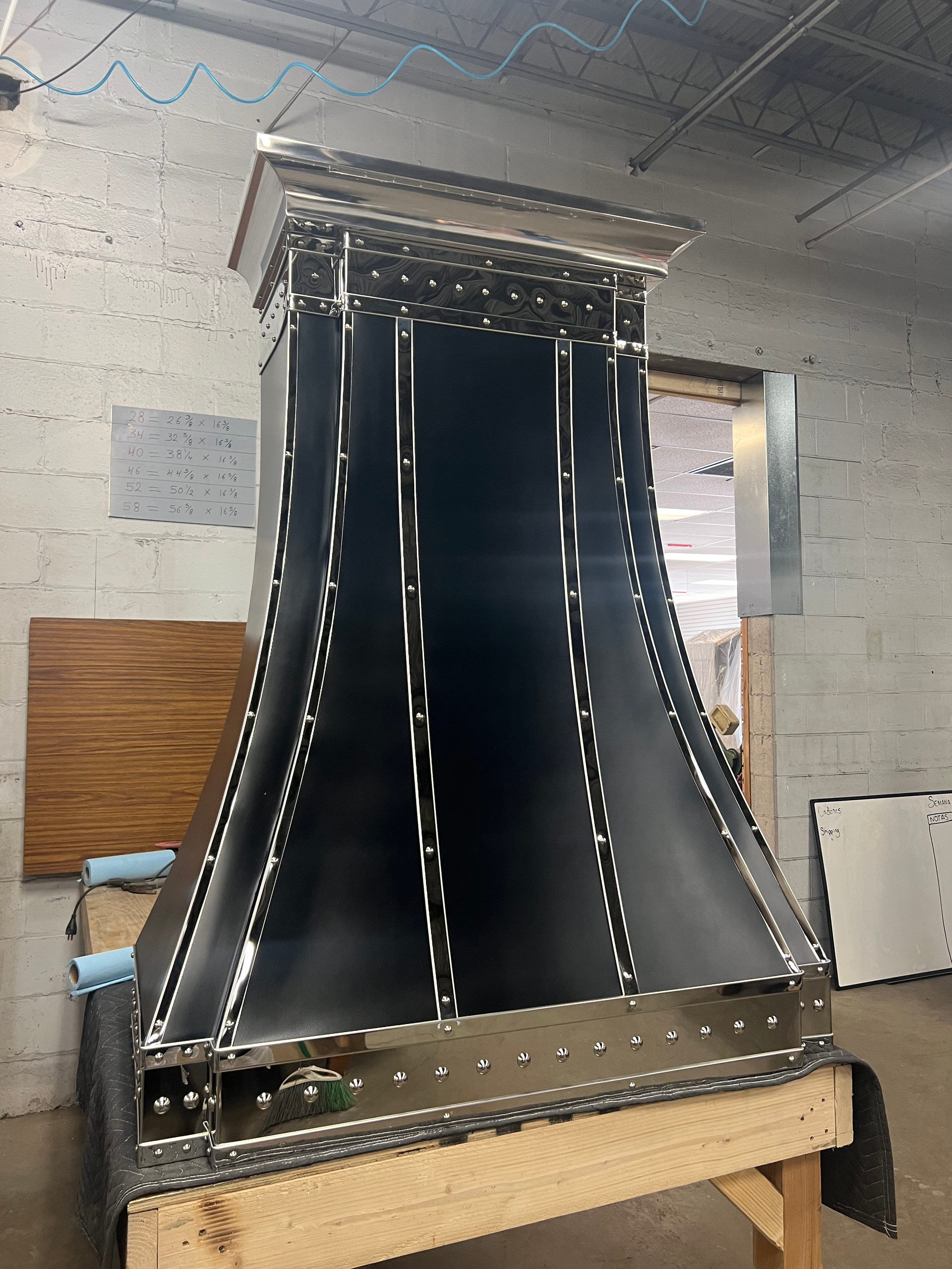 A black metal object is sitting on a wooden table