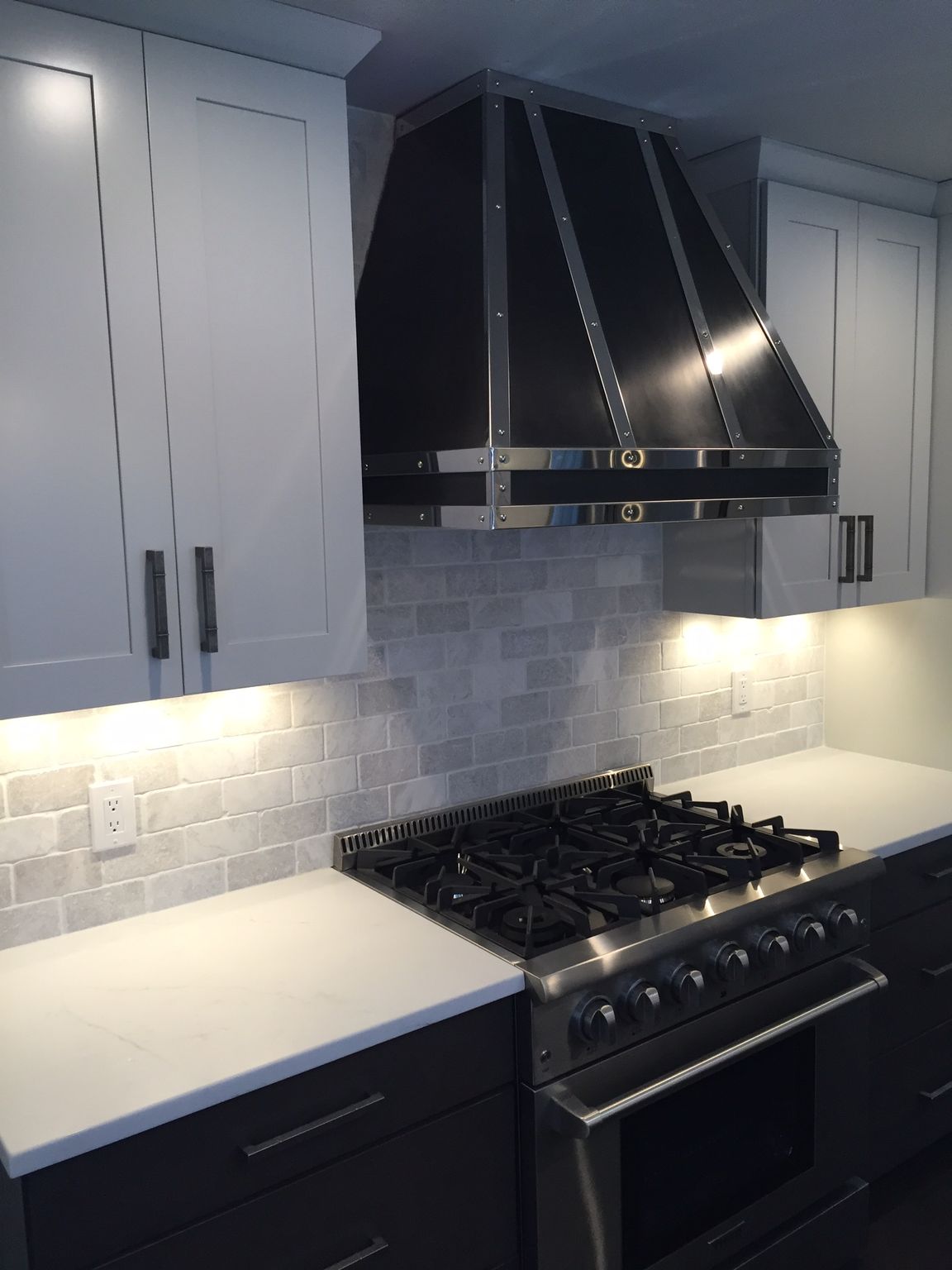 A kitchen with stainless steel appliances and white cabinets