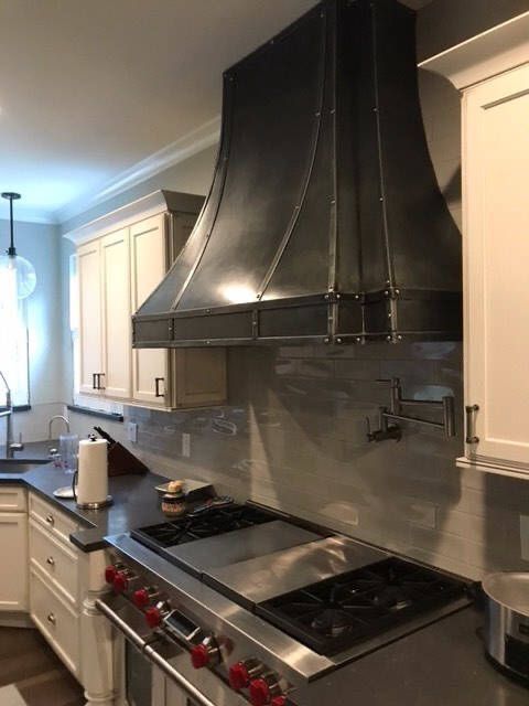 A kitchen with stainless steel appliances and white cabinets