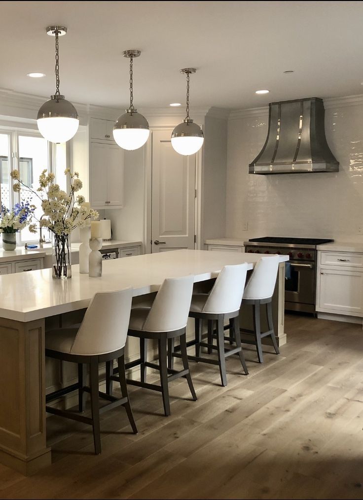 A kitchen with a large island and stools