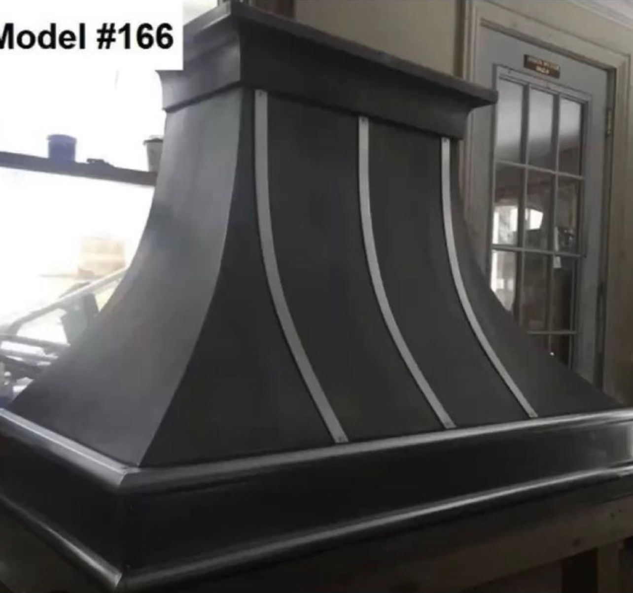 A model # 166 hood is sitting in front of a window