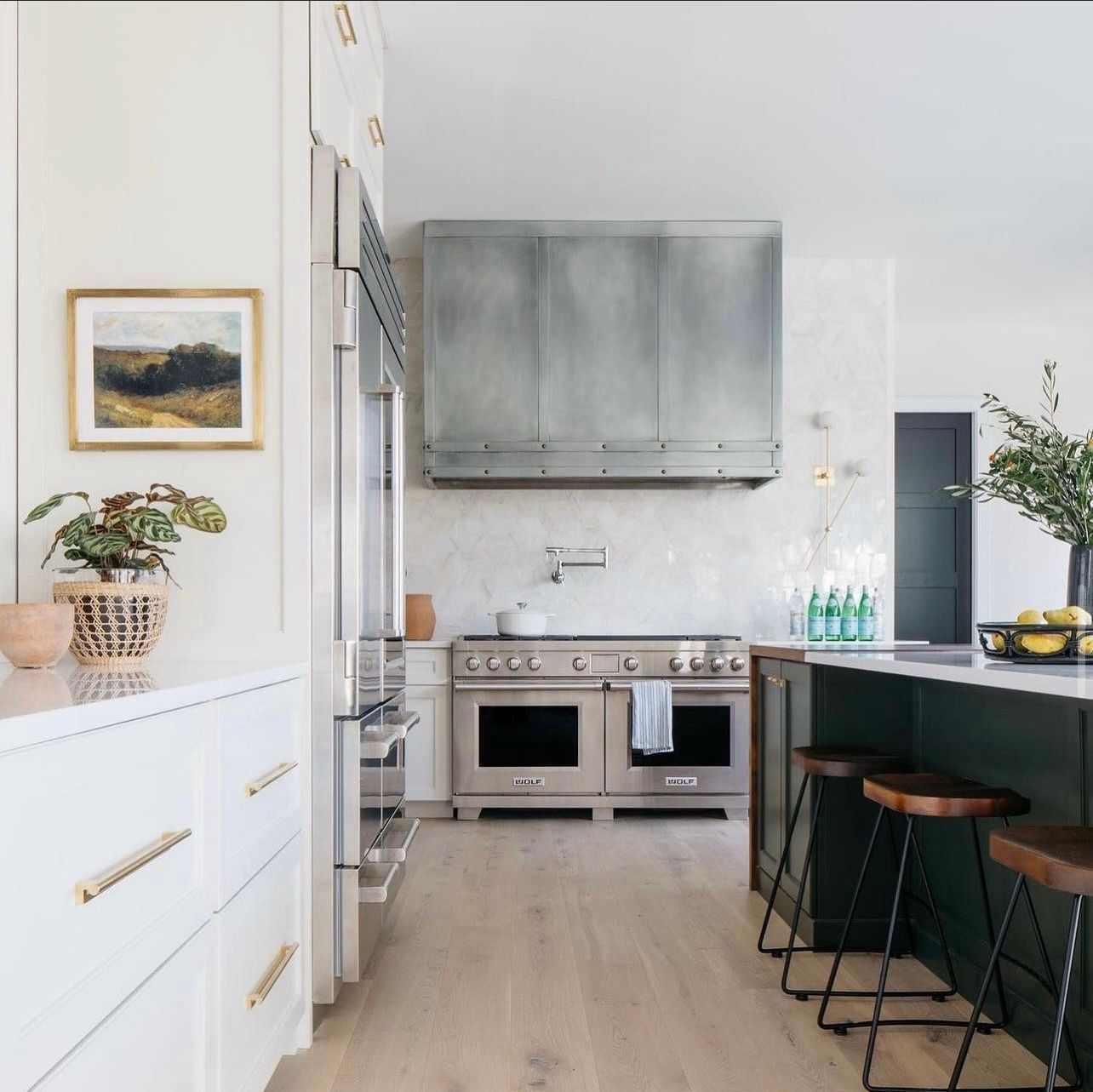 A kitchen with stainless steel appliances and white cabinets