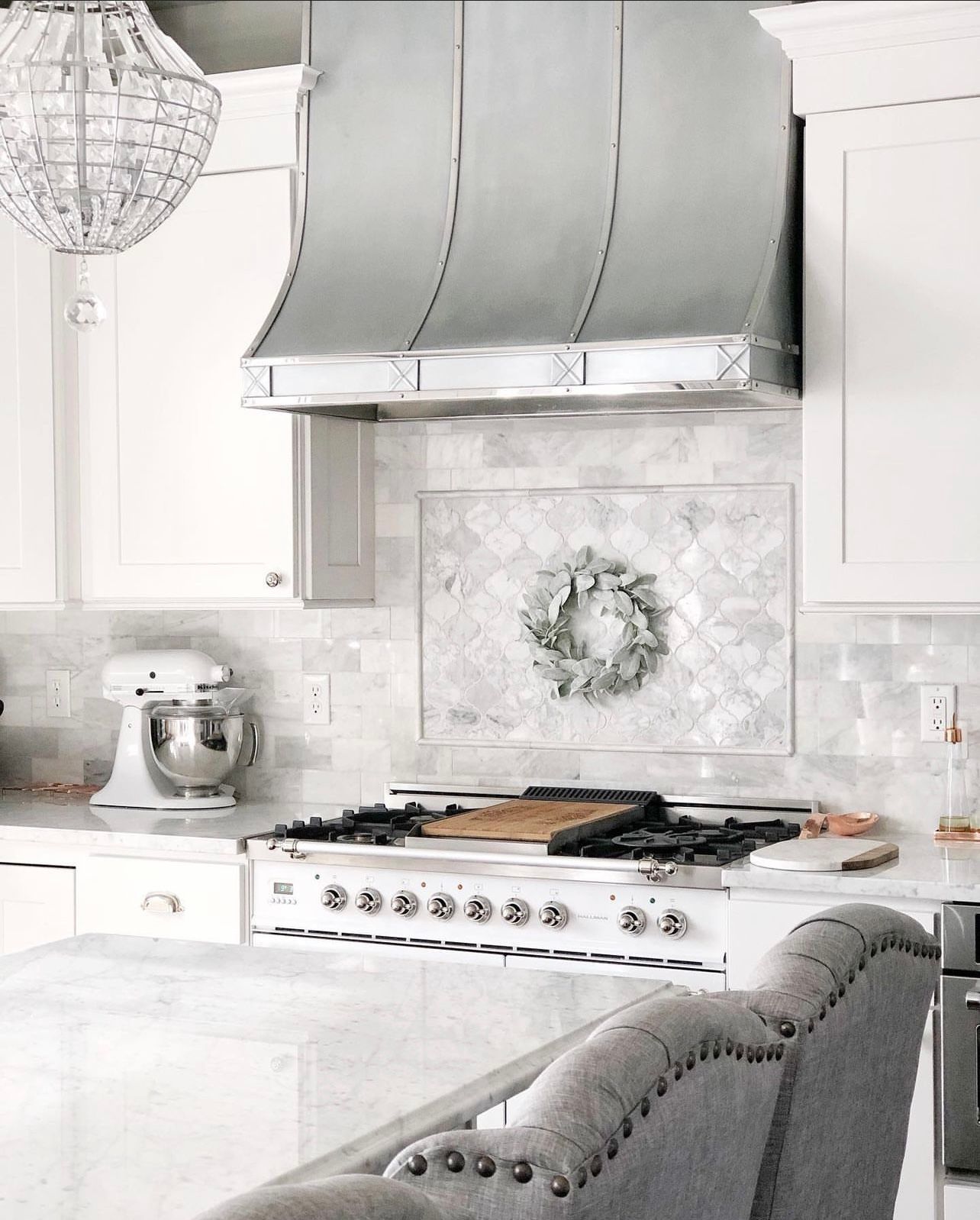 A kitchen with white cabinets and a stove top oven