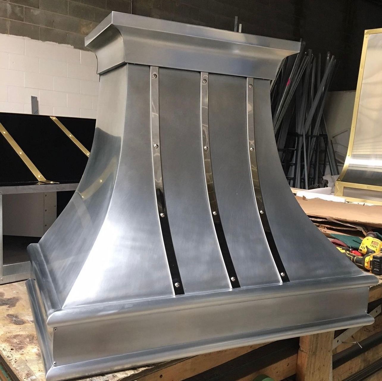 A large metal object is sitting on a wooden table