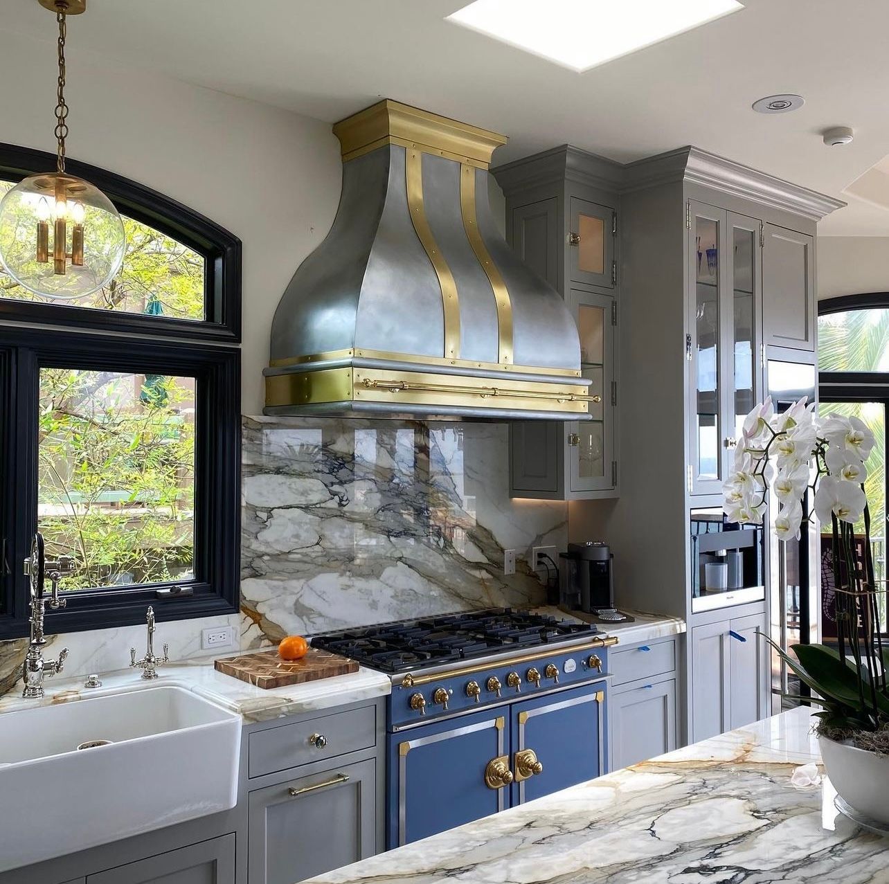 A kitchen with a stove top oven and a sink