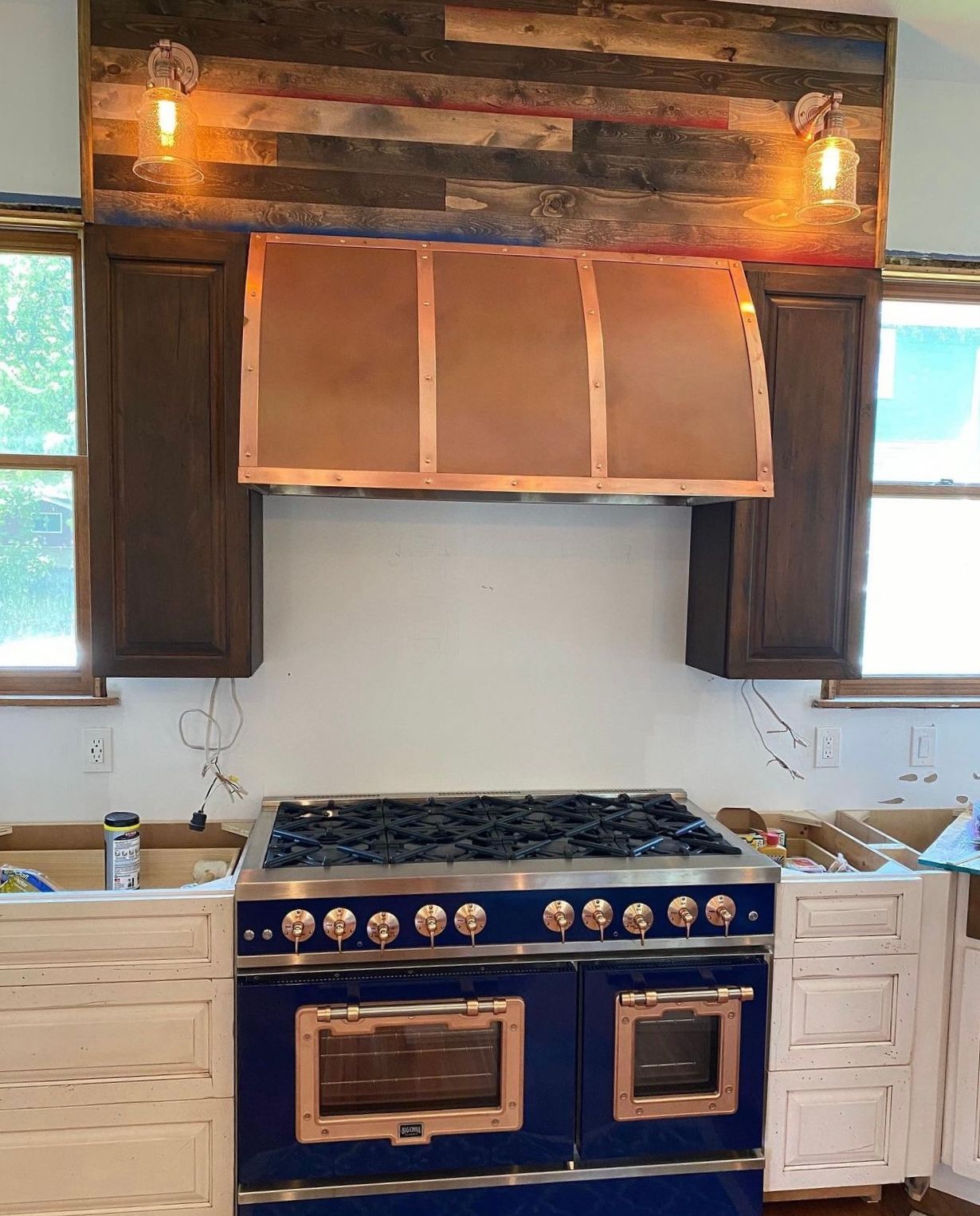A kitchen with a blue stove and wooden cabinets