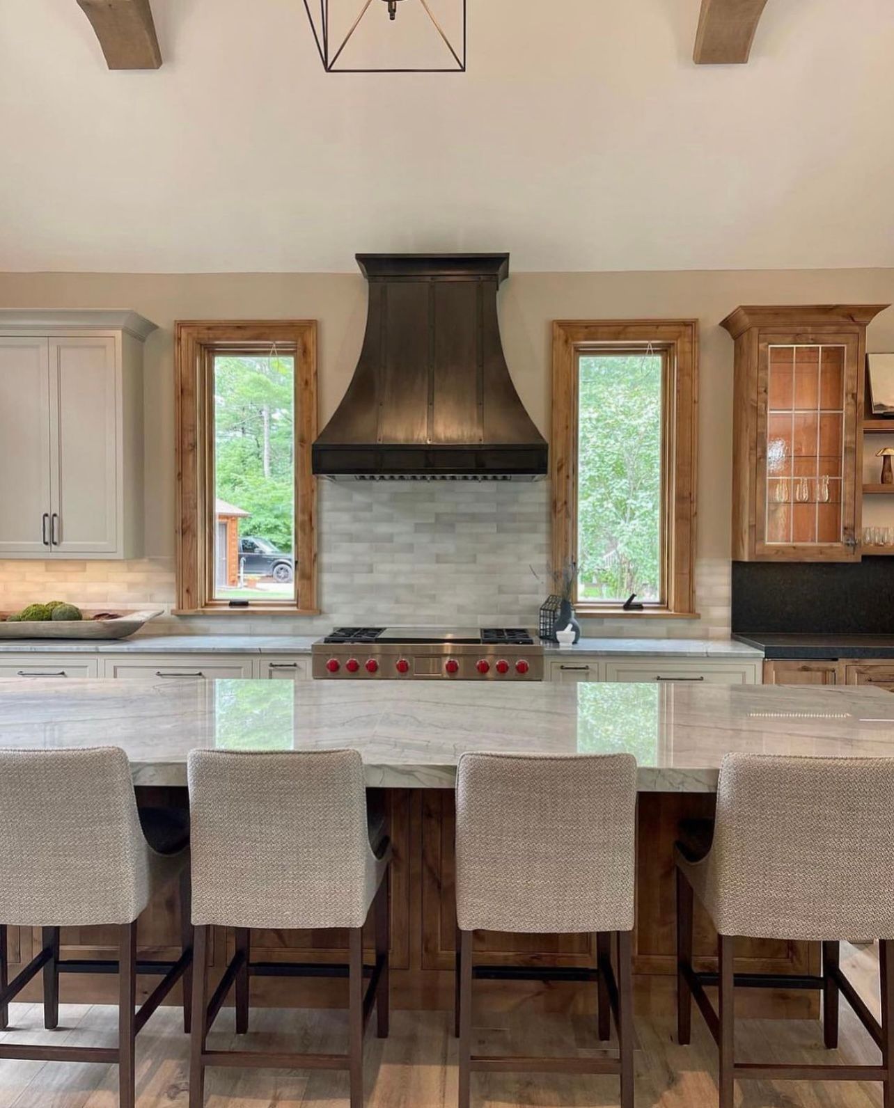 A kitchen with a large island and a stove top oven.