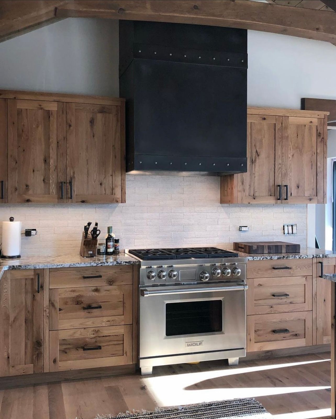 A kitchen with stainless steel appliances and wooden cabinets
