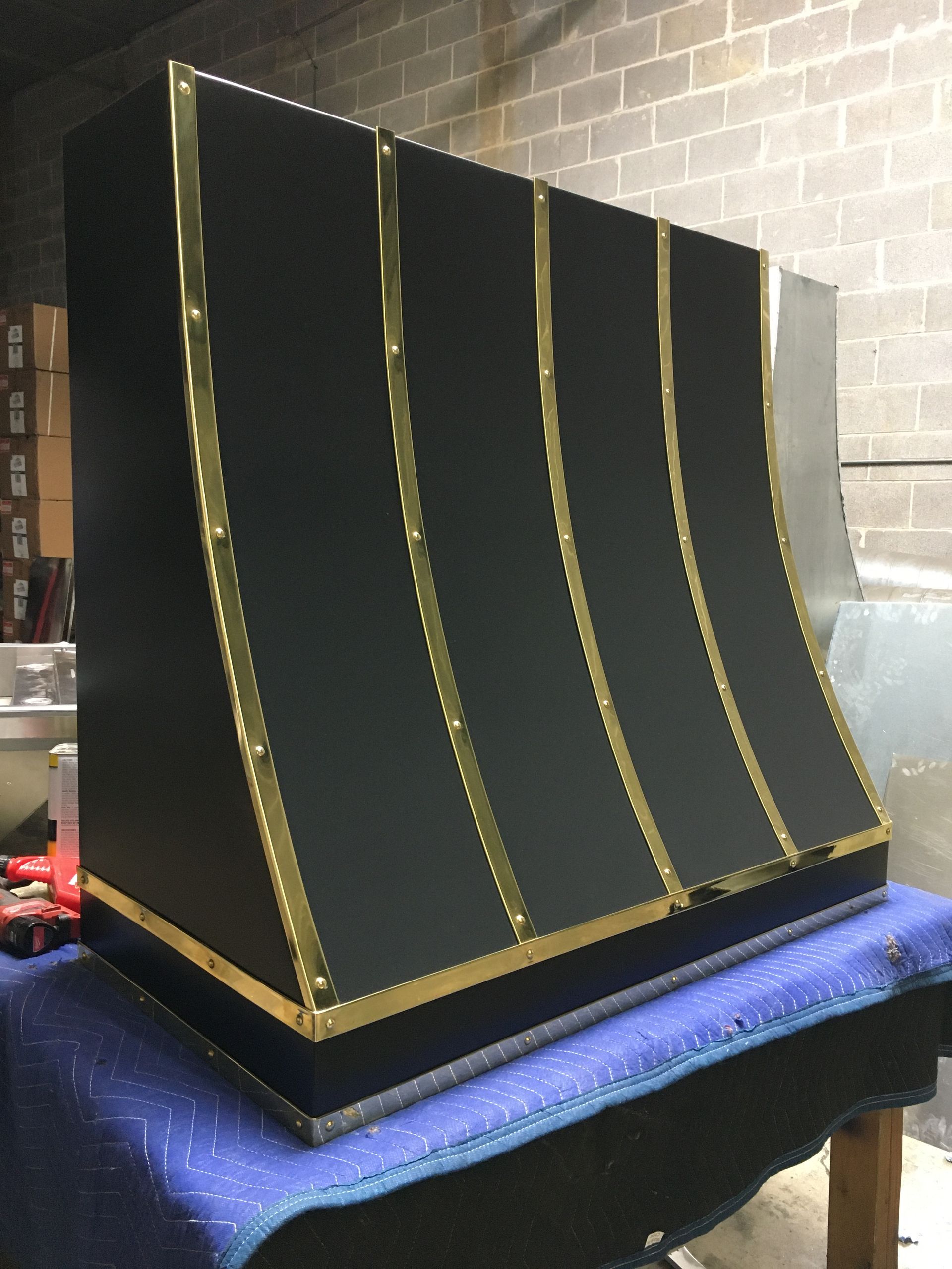 A black box with gold stripes sits on a table