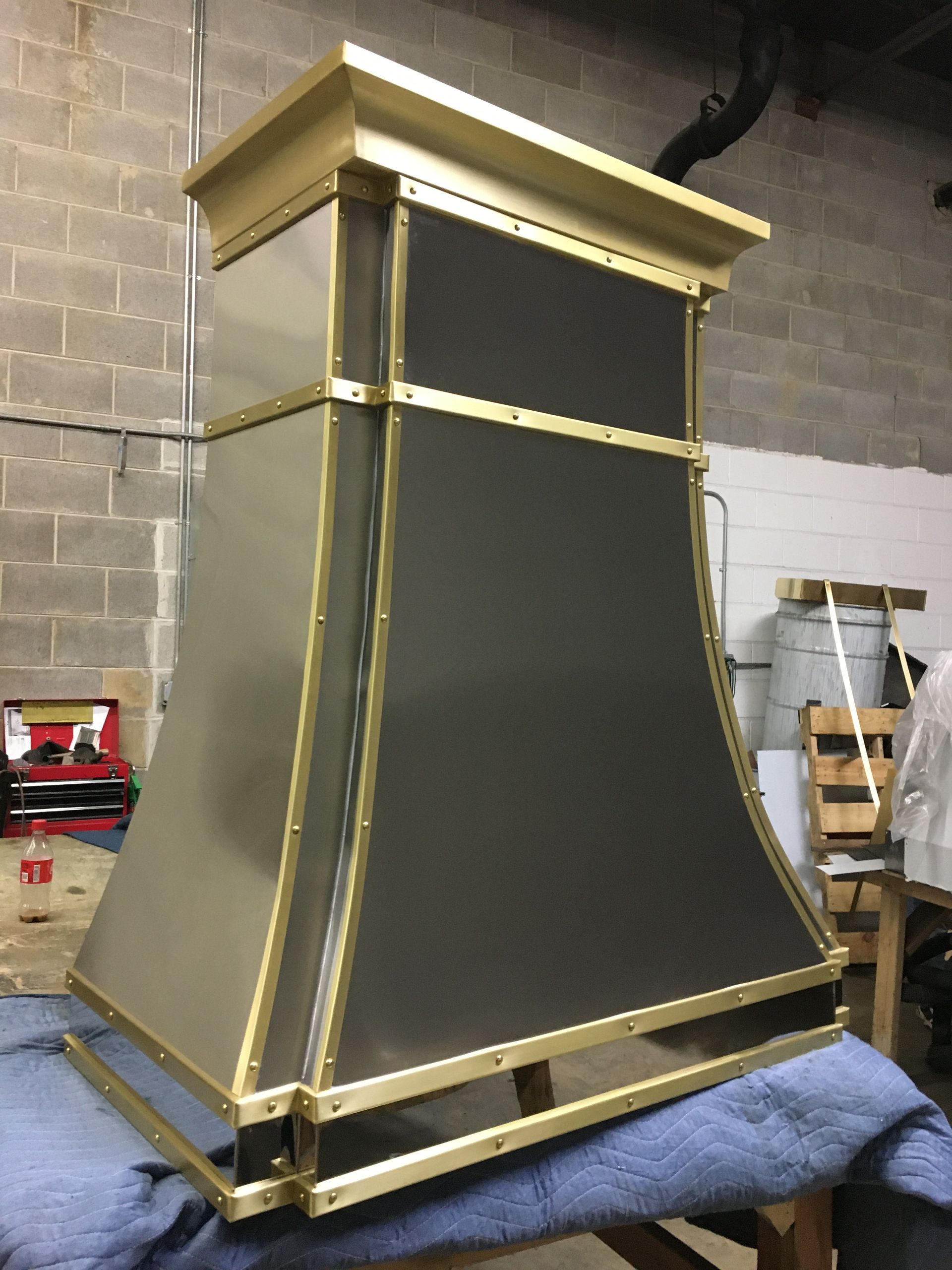 A black and gold hood is sitting on a table