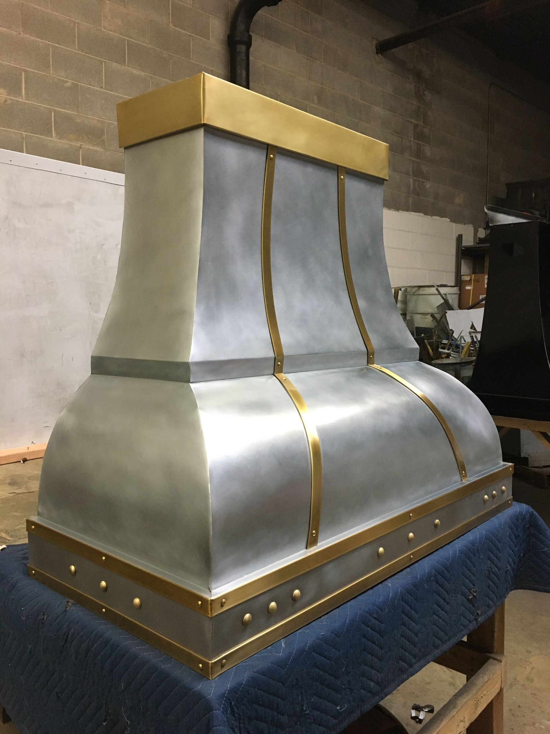A silver and gold hood is sitting on a table