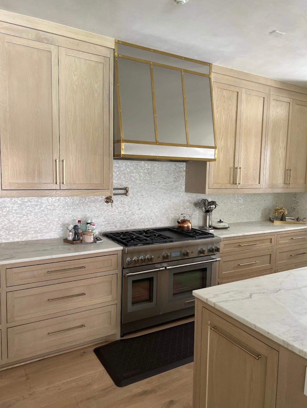 A kitchen with stainless steel appliances and wooden cabinets.