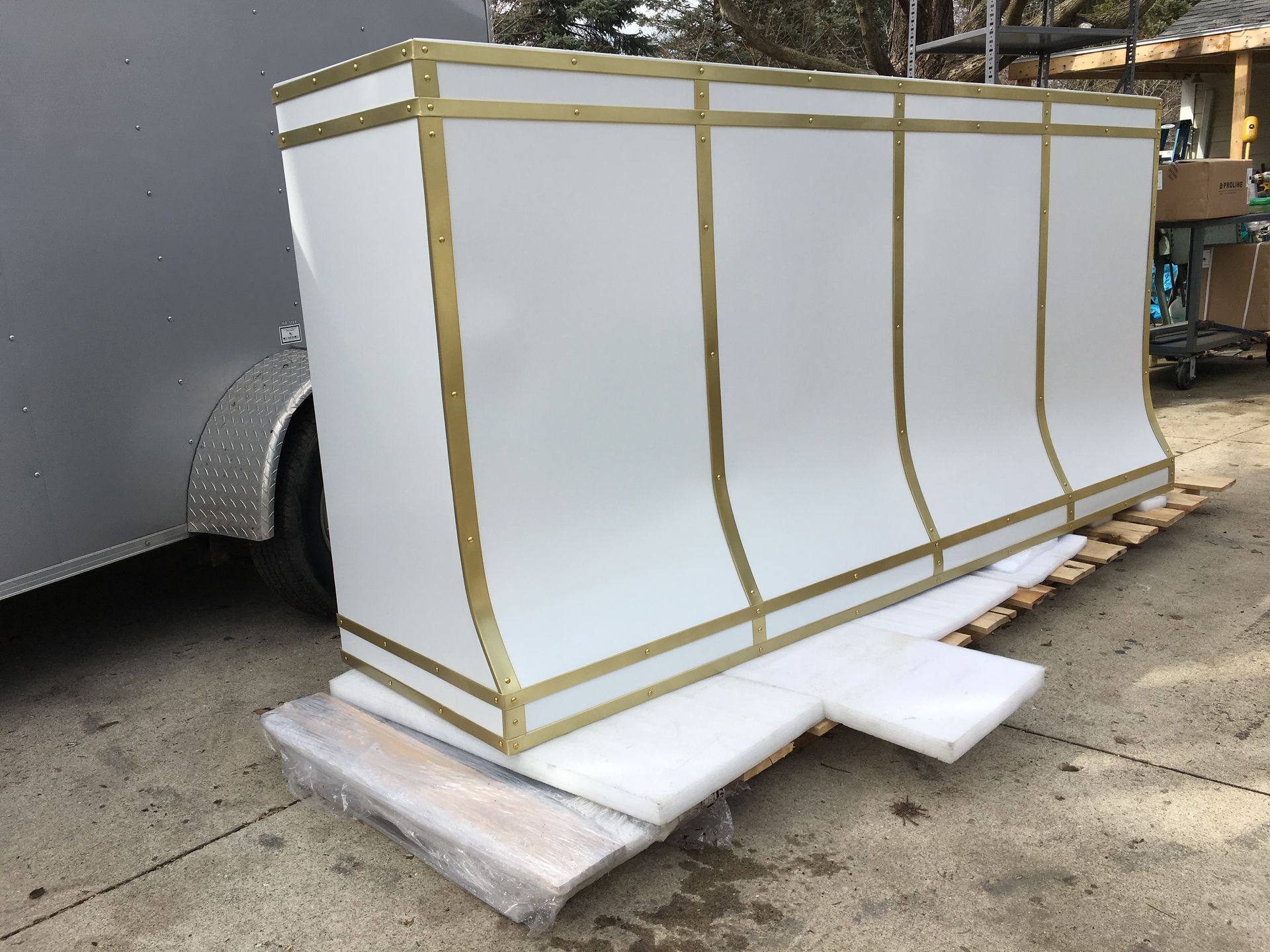 A large white object is sitting on top of a wooden pallet.