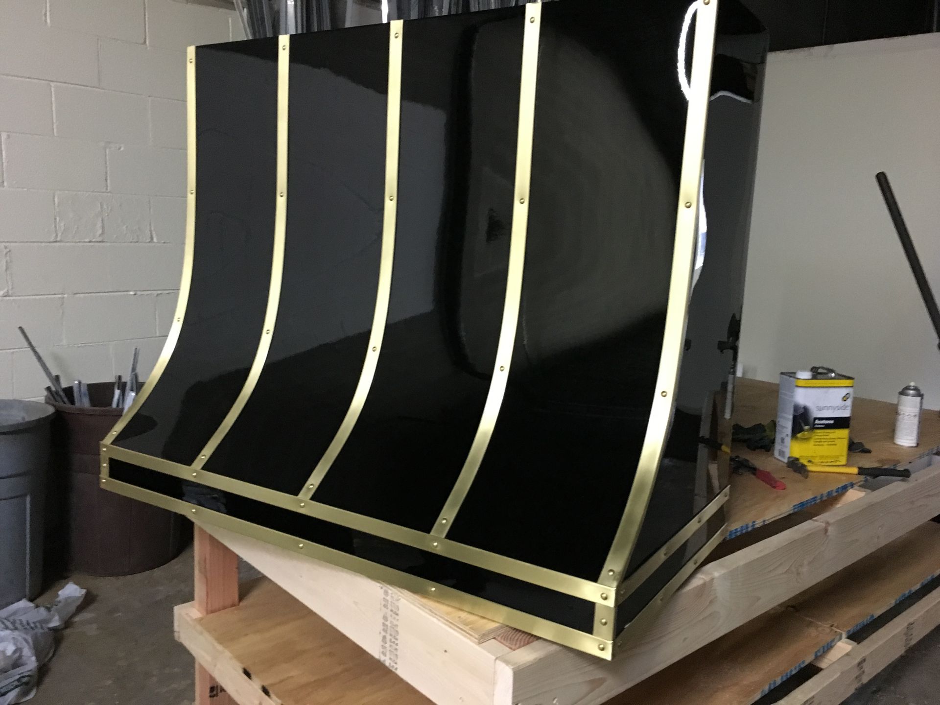 A black and gold item is sitting on top of a wooden table.