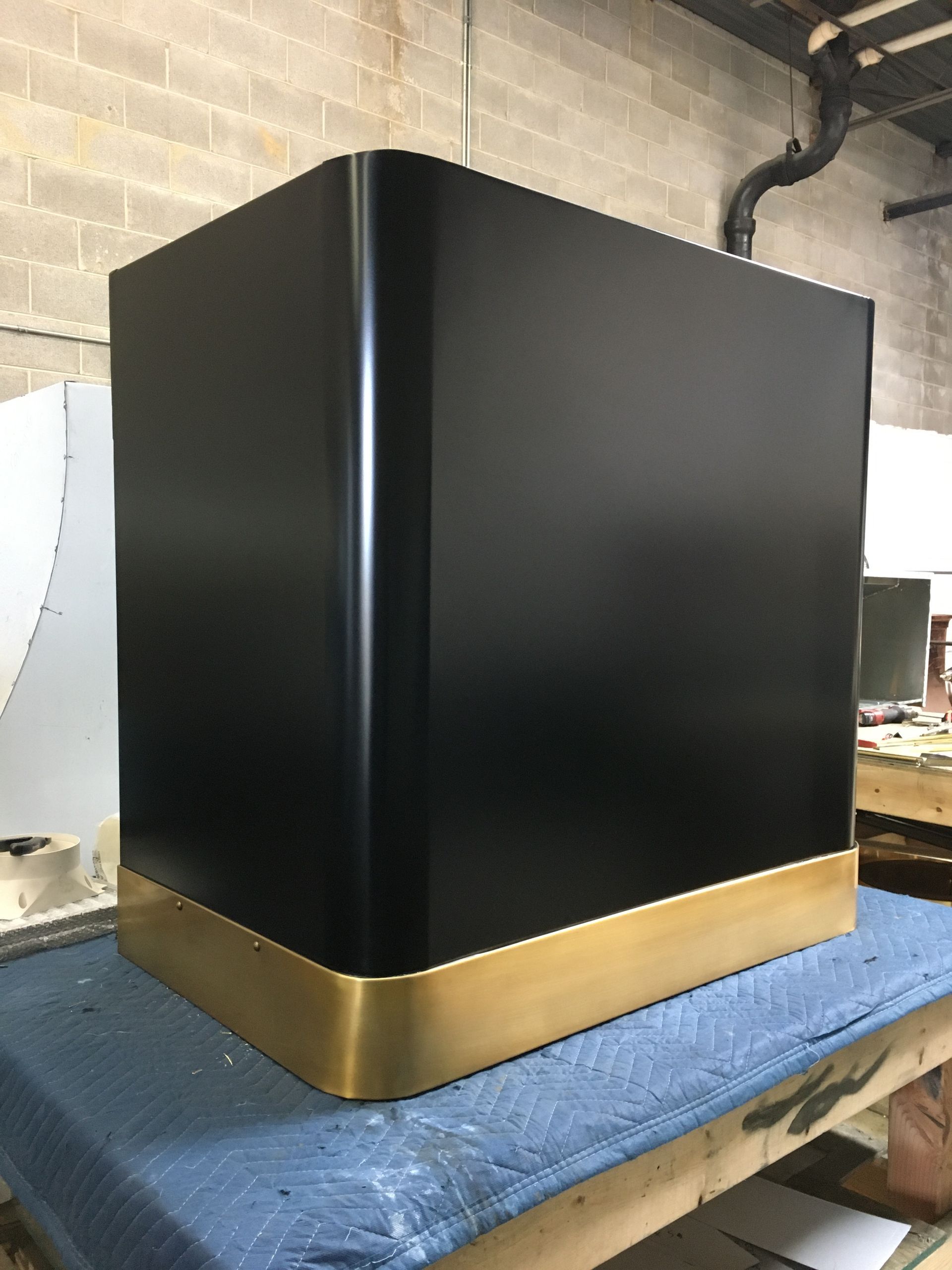 A black box with a gold trim is sitting on a table.