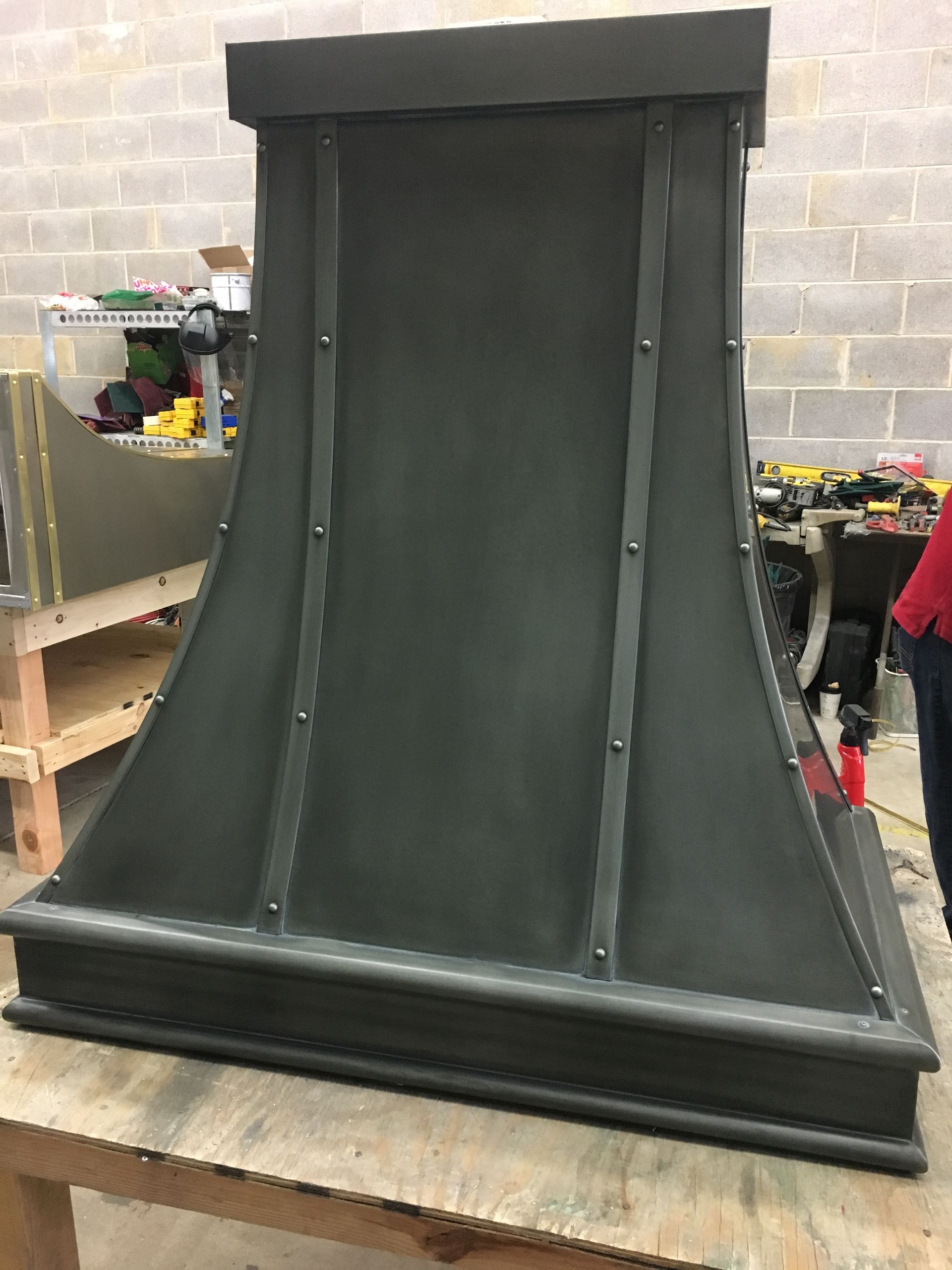 A black hood is sitting on top of a wooden table.