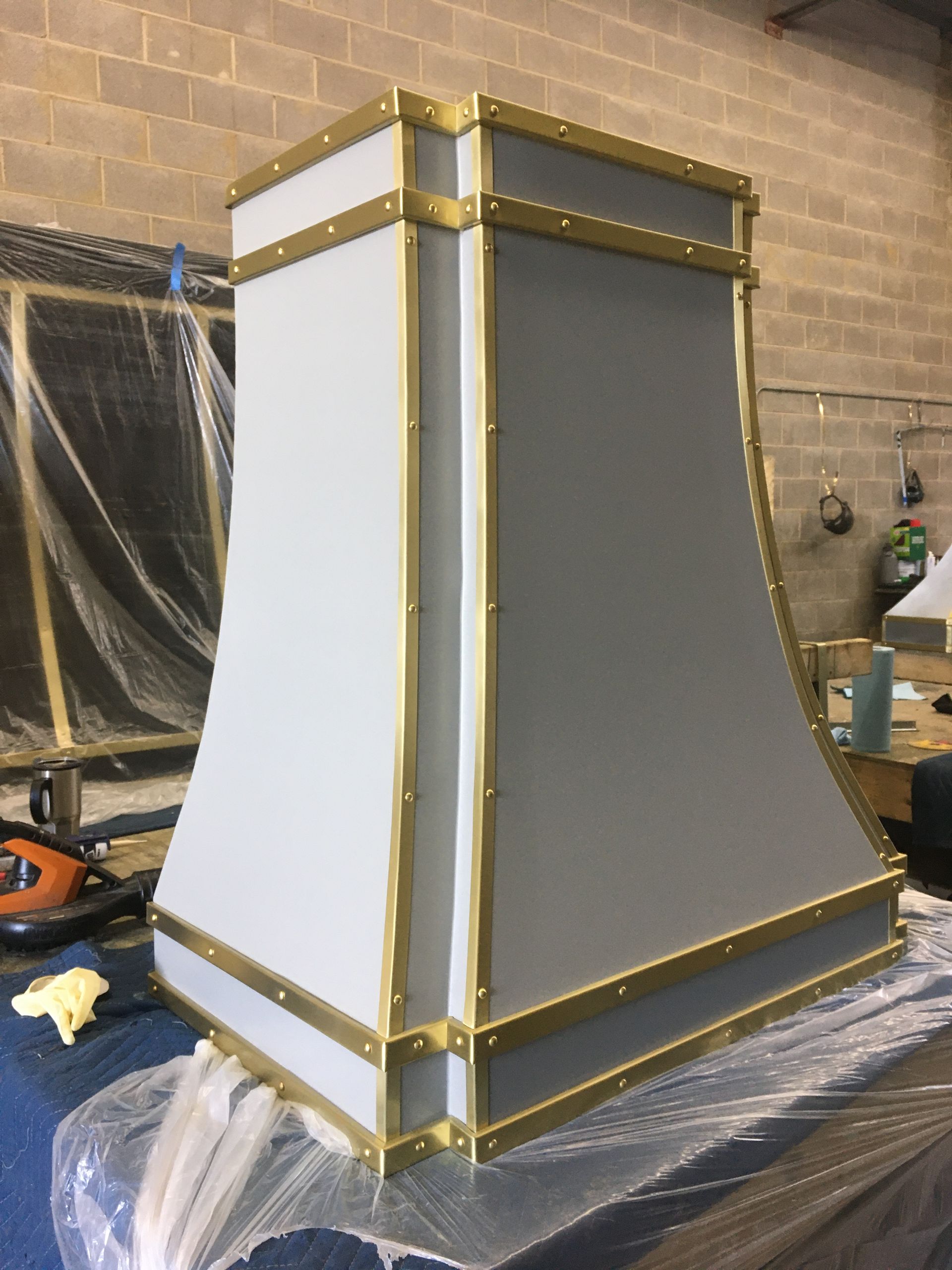 A white lamp with gold trim is sitting on a table