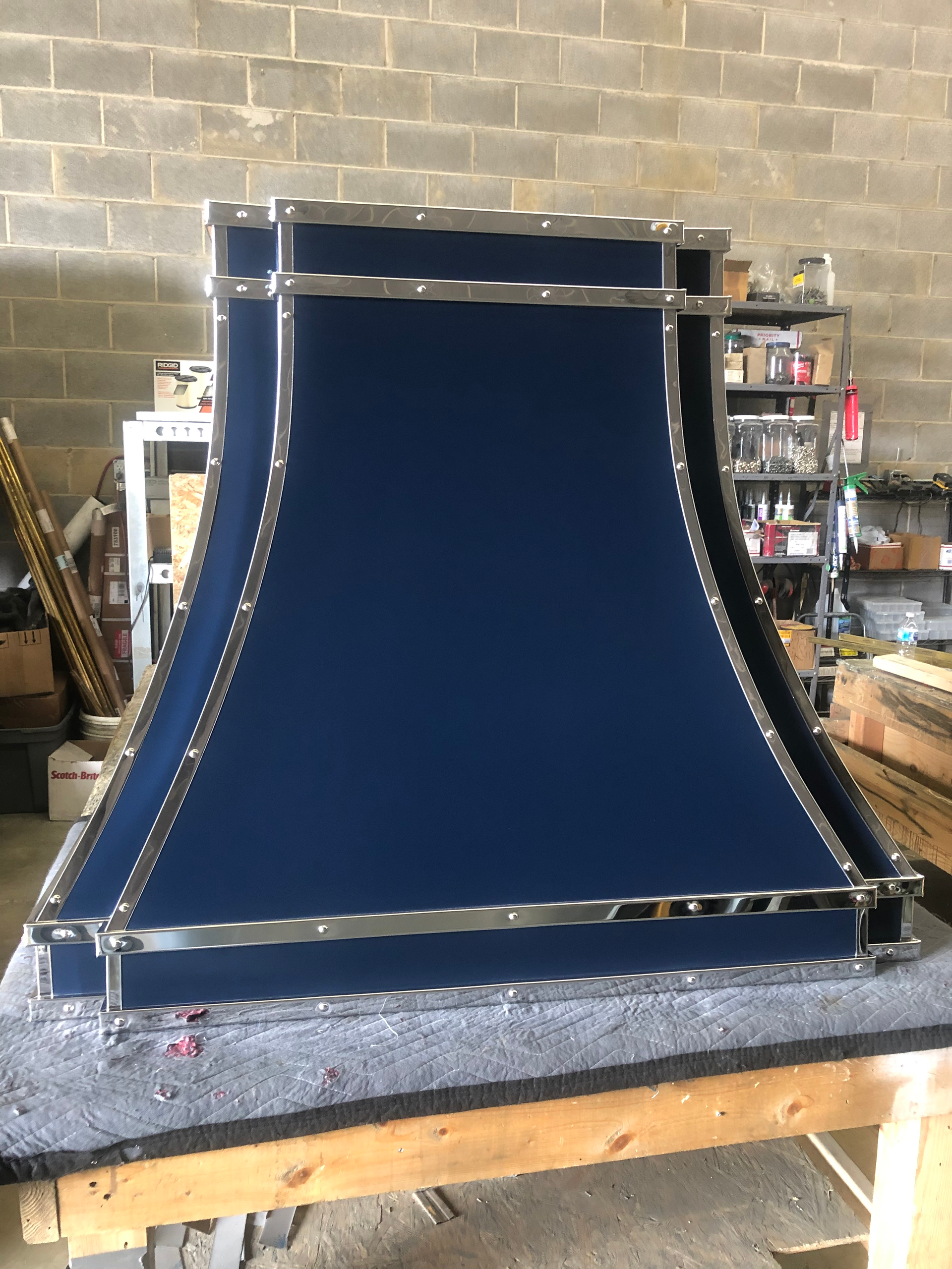 A blue hood is sitting on top of a wooden table