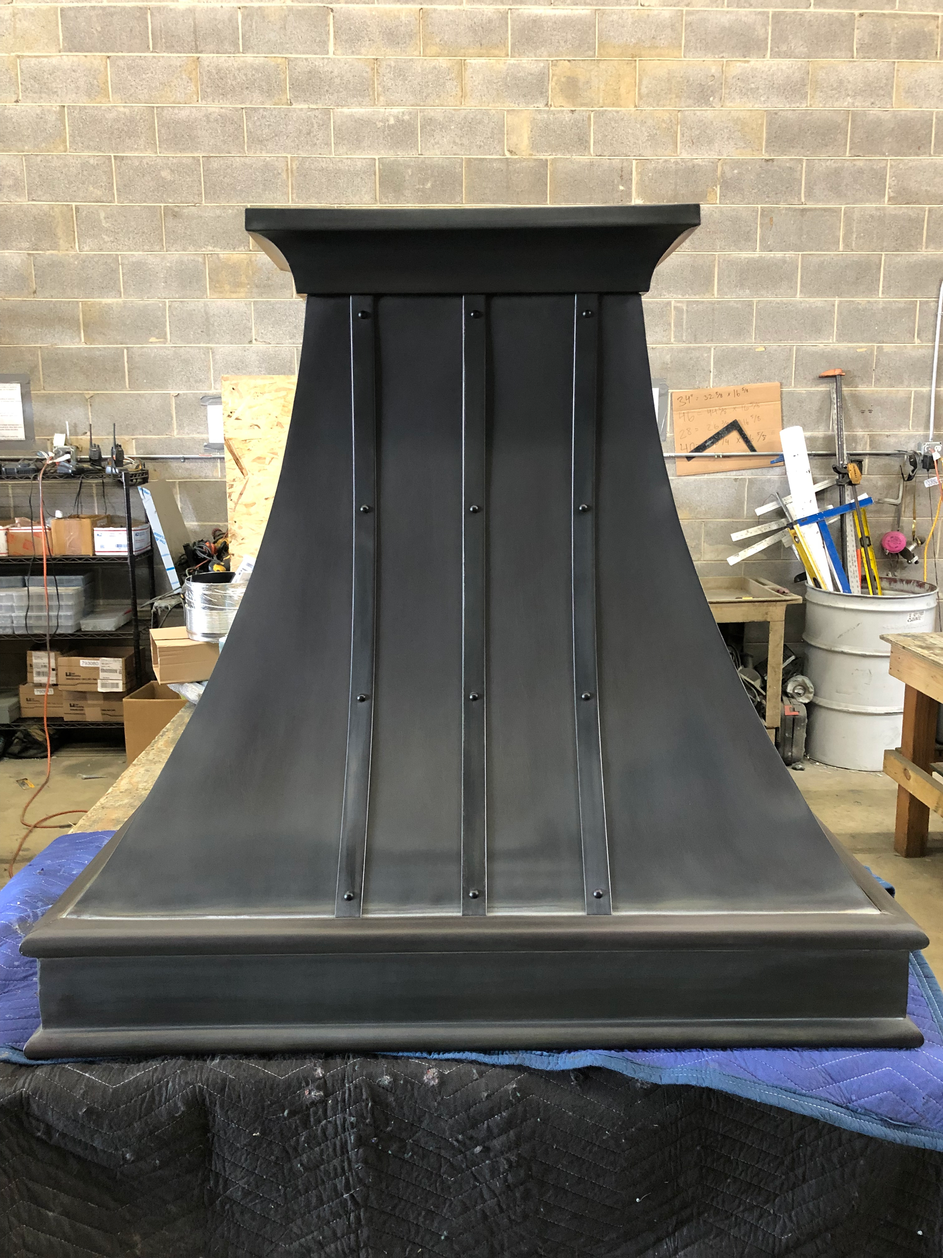 A black hood is sitting on a table in a room.