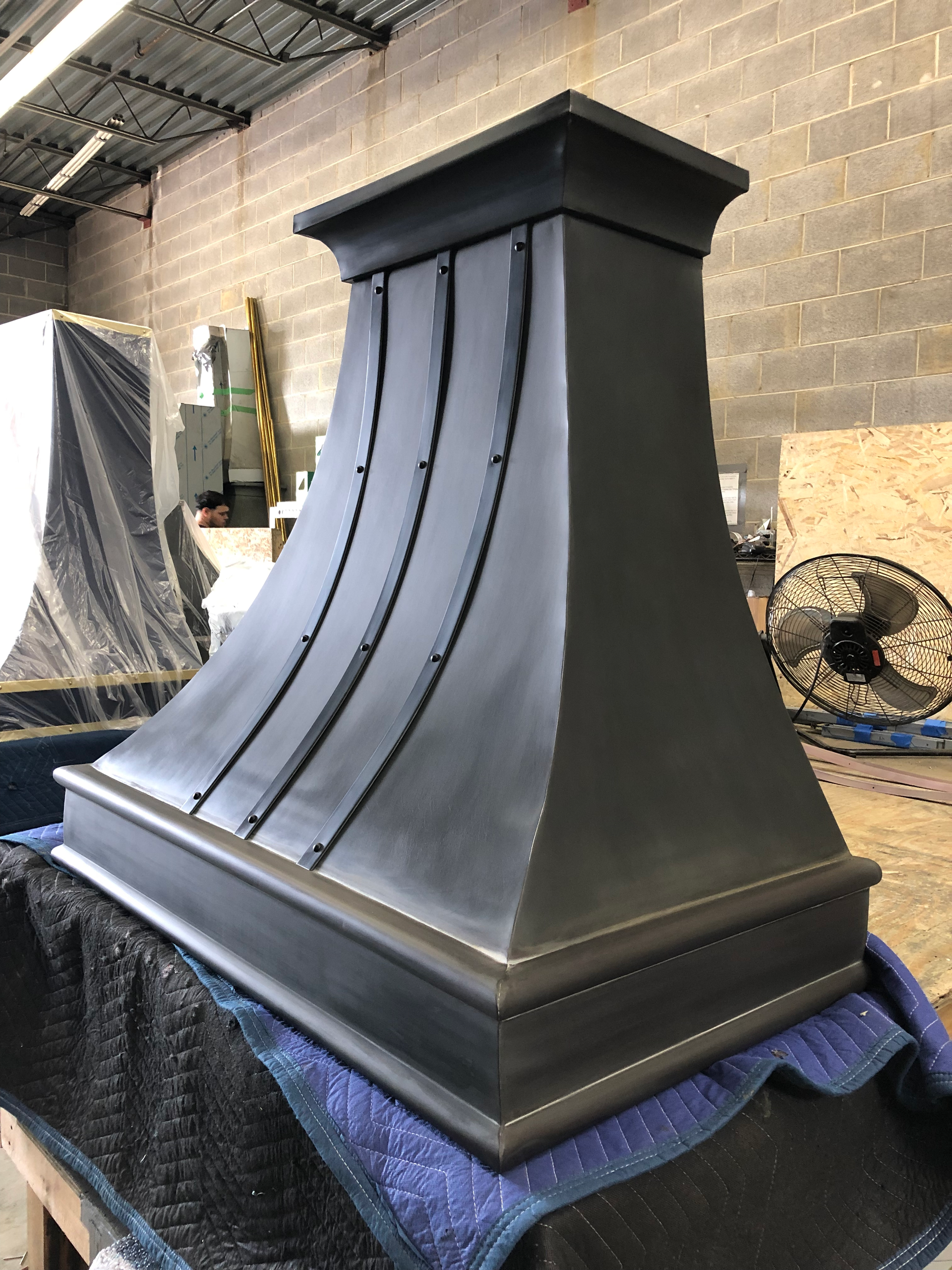 A black chimney is sitting on top of a blue blanket